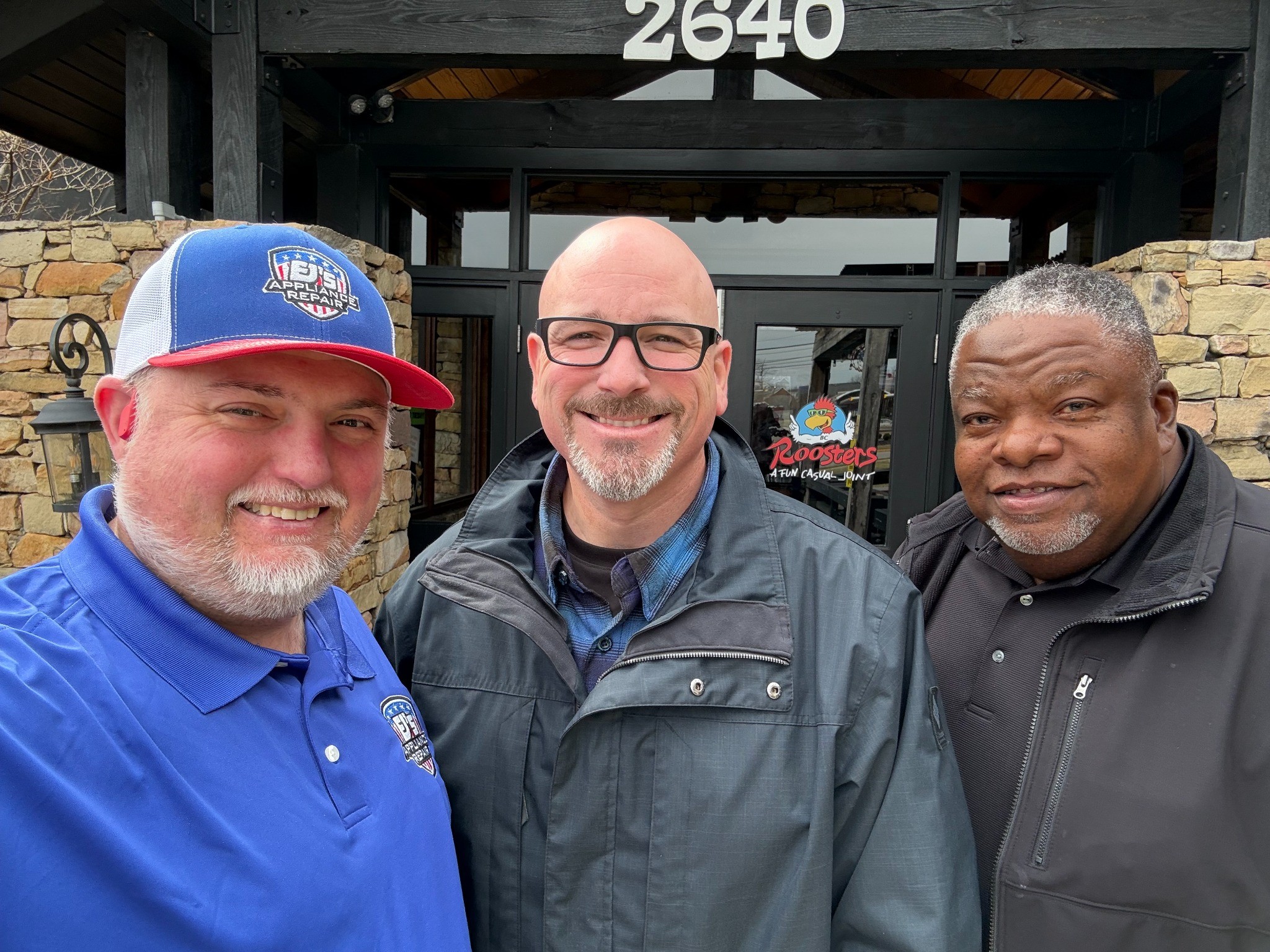 Everett 'EJ' Johnson with trusted local business partners outside Roosters