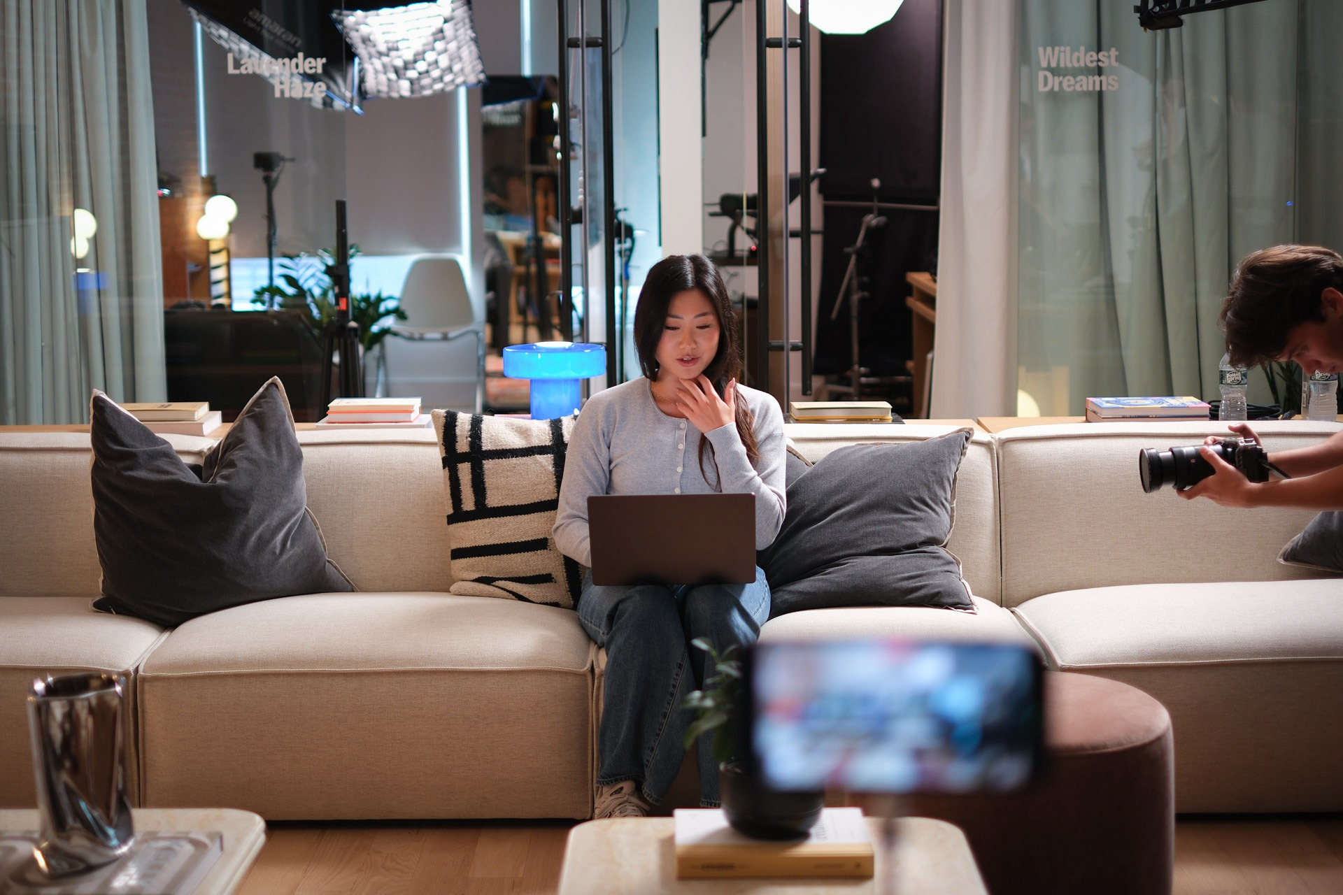 Megan Lieu recording content on couch