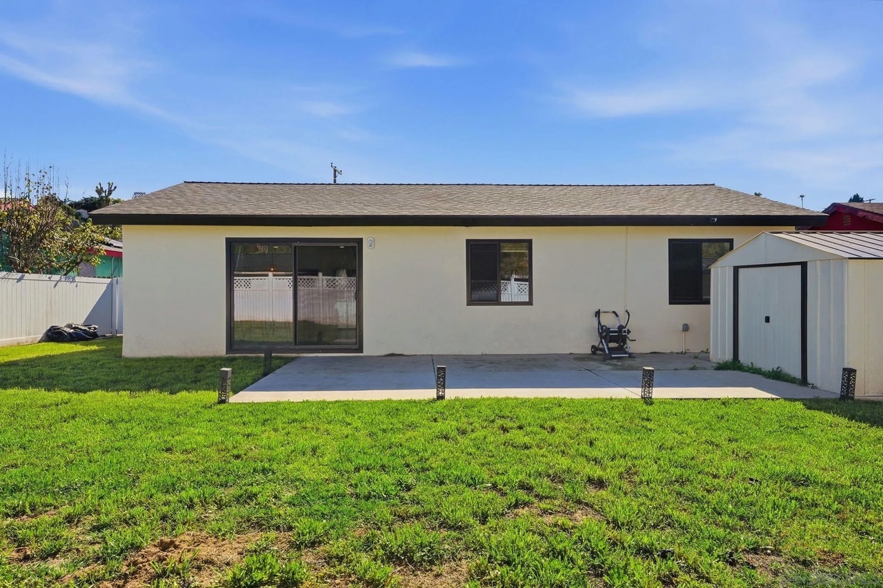 Backyard with a lawn and vinyl privacy fencing at 7742 Shorewood Drive in Skyline, San Diego, CA