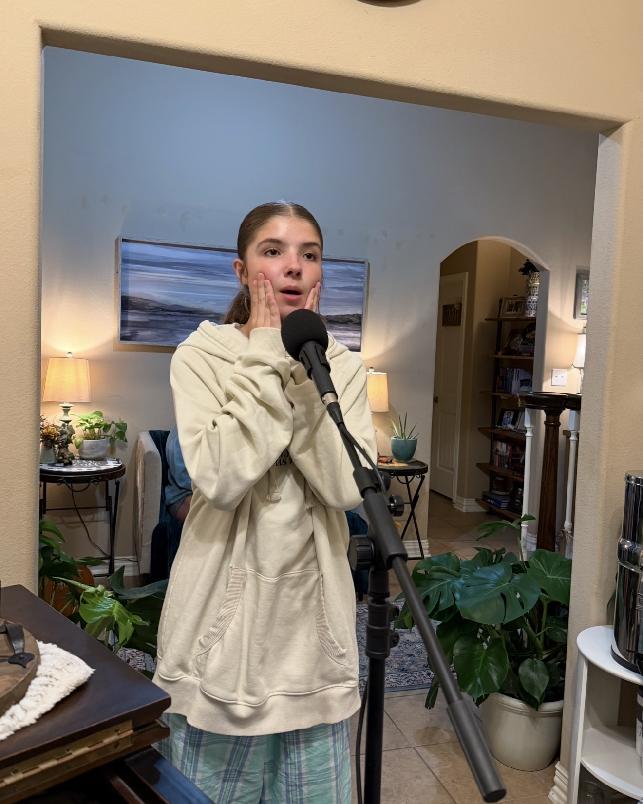 Student practicing balanced mix vocal technique at the microphone in studio