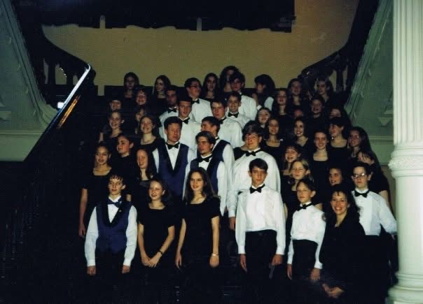 CYCSA choir performing in formal concert dress on the grand staircase at the Texas State Capitol