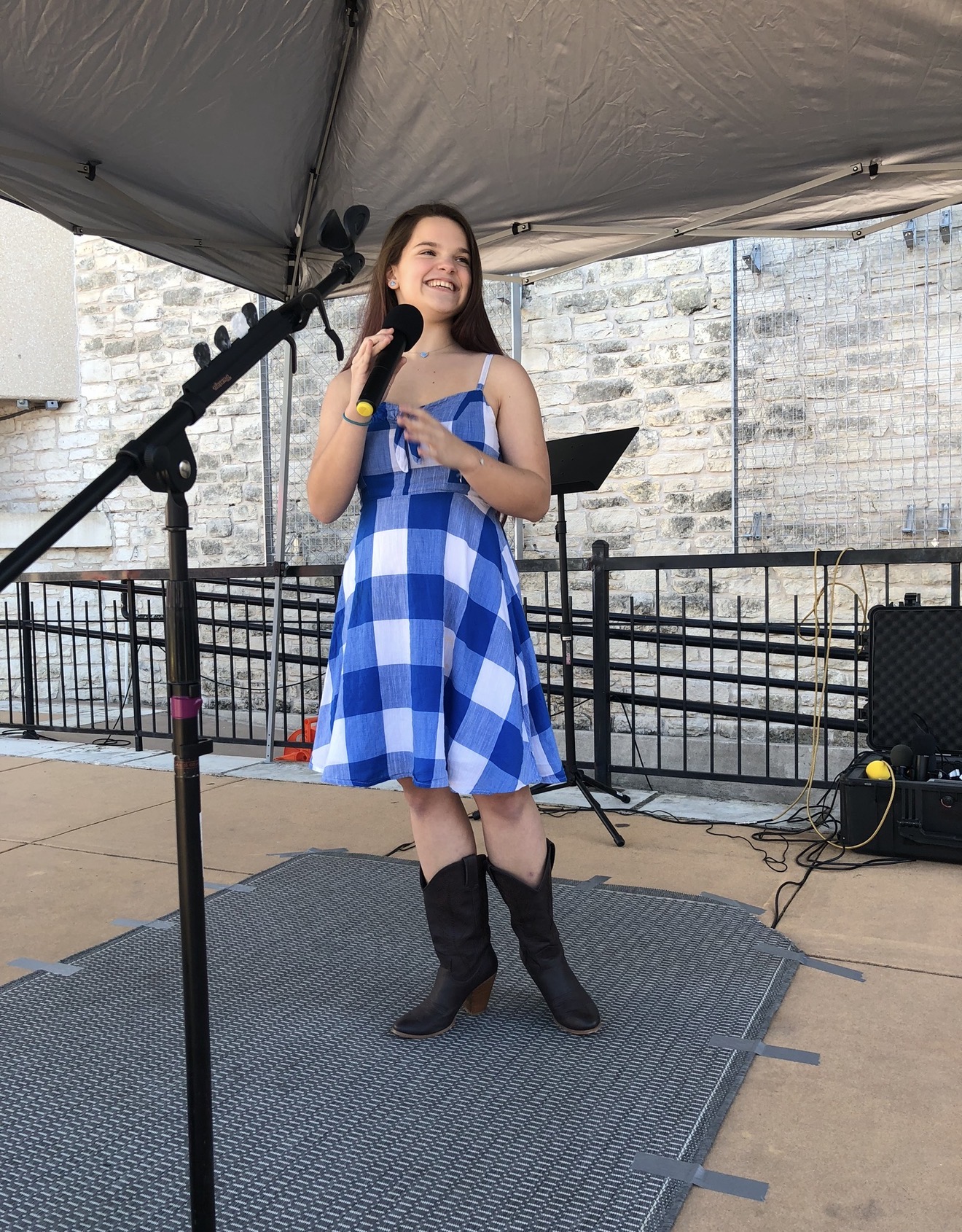 Vocal Edge Studio student performing live on stage outdoors