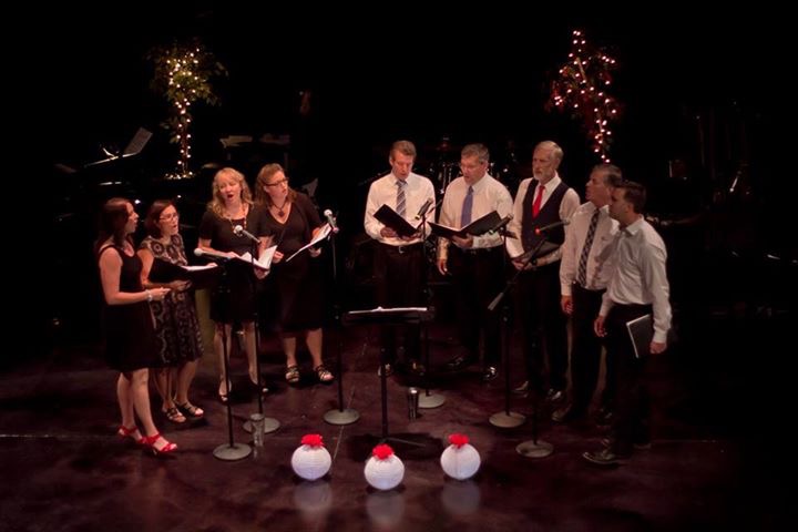 Laurie Winckel performing live with Gradient a cappella on stage under theatrical lighting