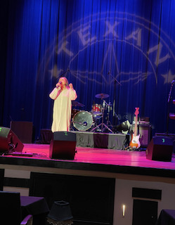 Jenny Cova performing on stage at The Texan Theater
