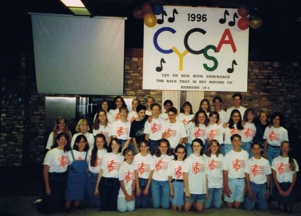 CYCSA Choir group on stage in 1996: Let us run with endurance the race that is set before us (Hebrews 12:1)