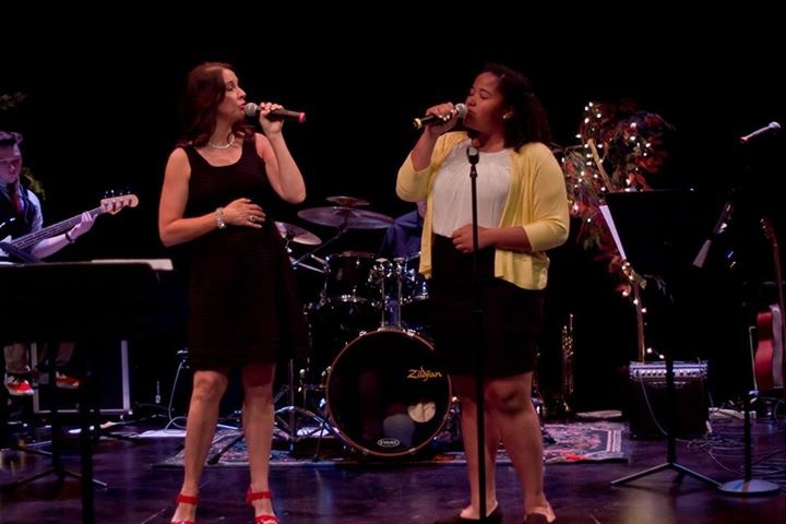 Laurie Winckel and student performing live on stage with live band