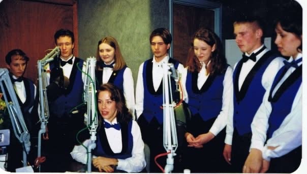 CYCSA vocalists in studio with Laurie Winckel at microphones during a live radio broadcast