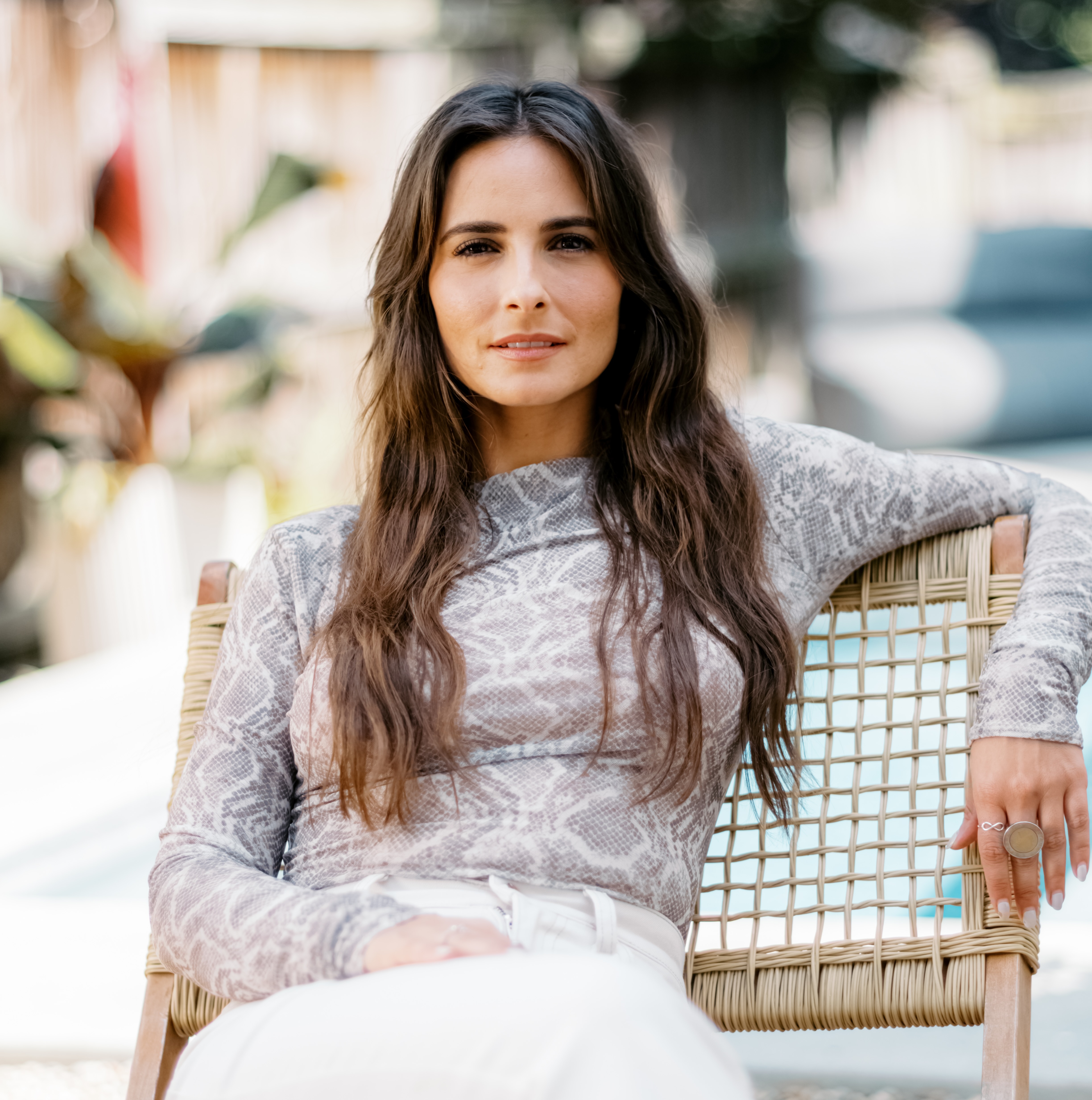 Celinne Da Costa sitting outdoors