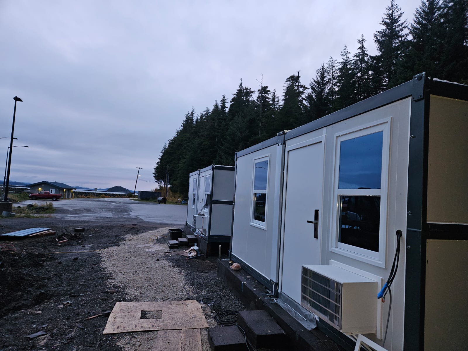 Close-up of deployed microshelters with exterior wall-mount AC and heat units installed
