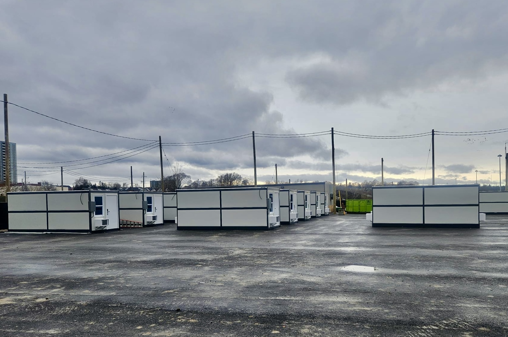 Organized outdoor cluster of modular microshelters with walkways and shared services