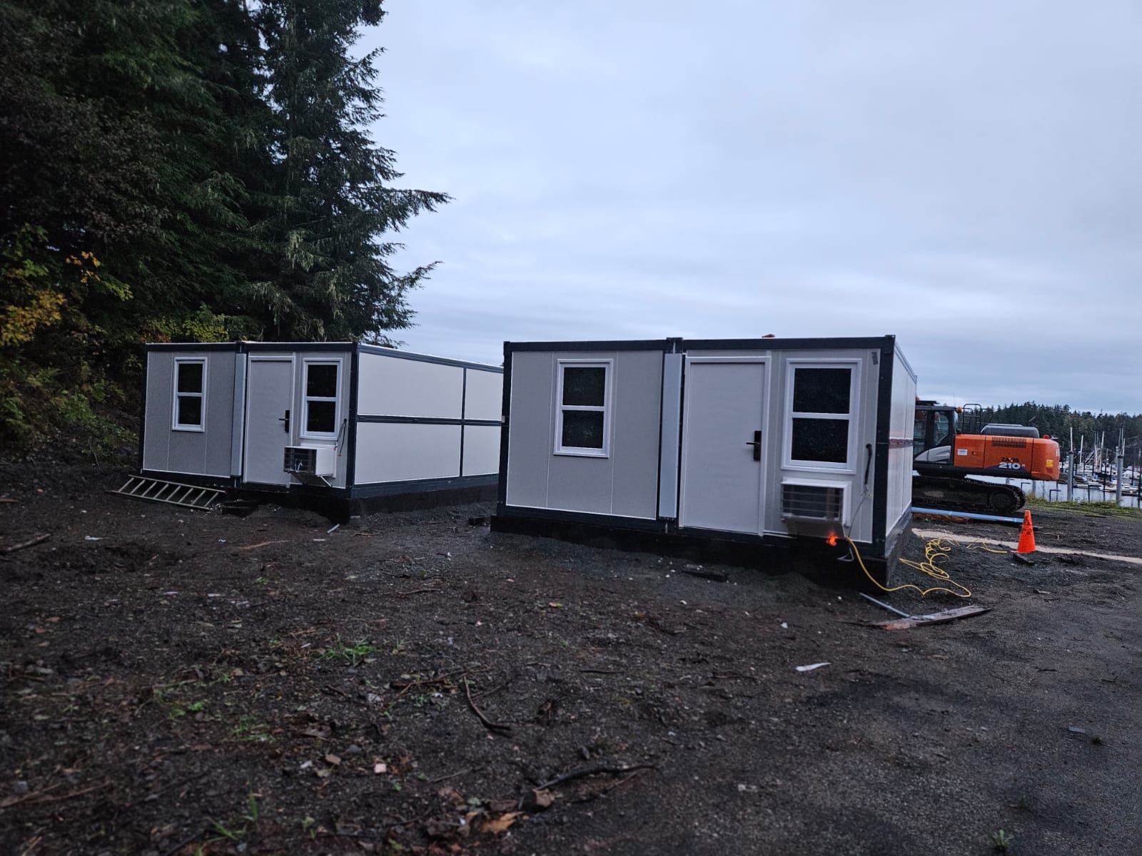 Two deployed microshelter units on graded site foundation with climate control