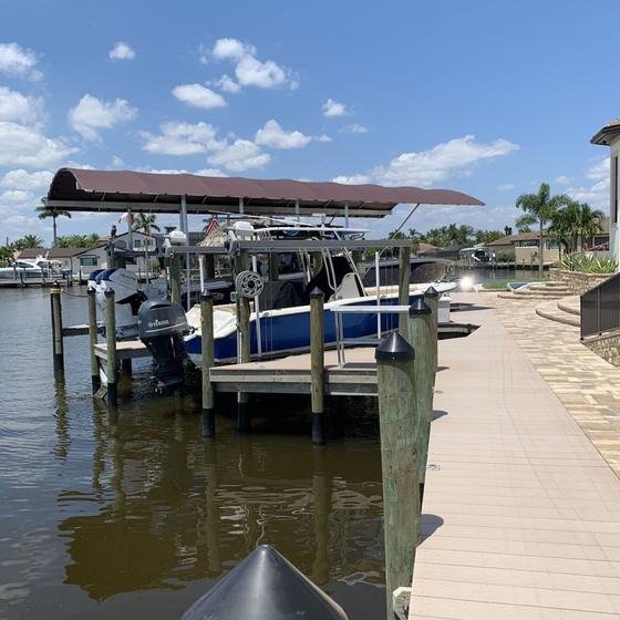 After: completed custom vinyl dock, tiki hut, and boat lift in Cape Coral