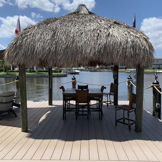 Curved grated walkway leading out to a tiki dock
