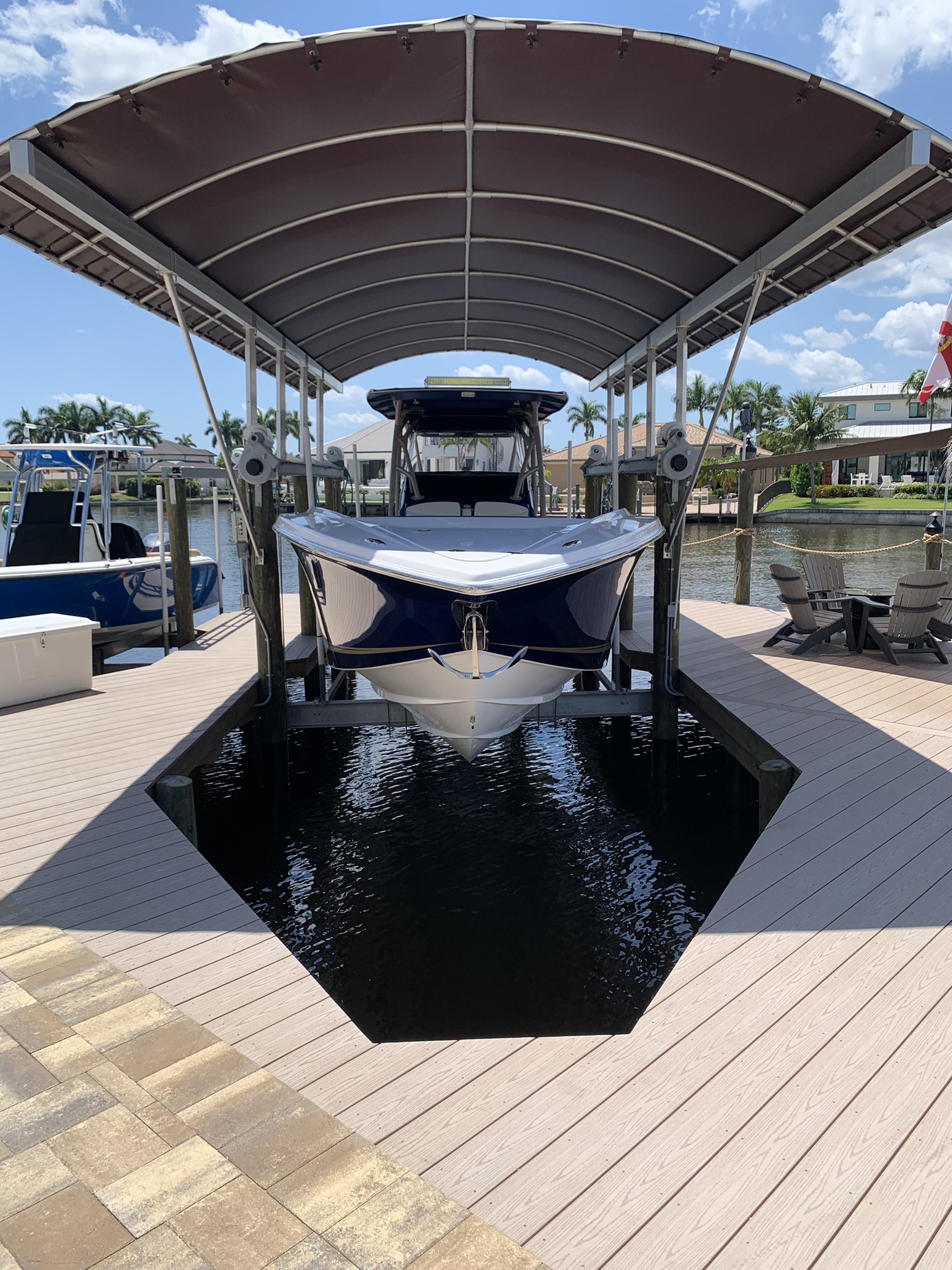 Custom boat dock slip with covered canopy and boat lift in Cape Coral