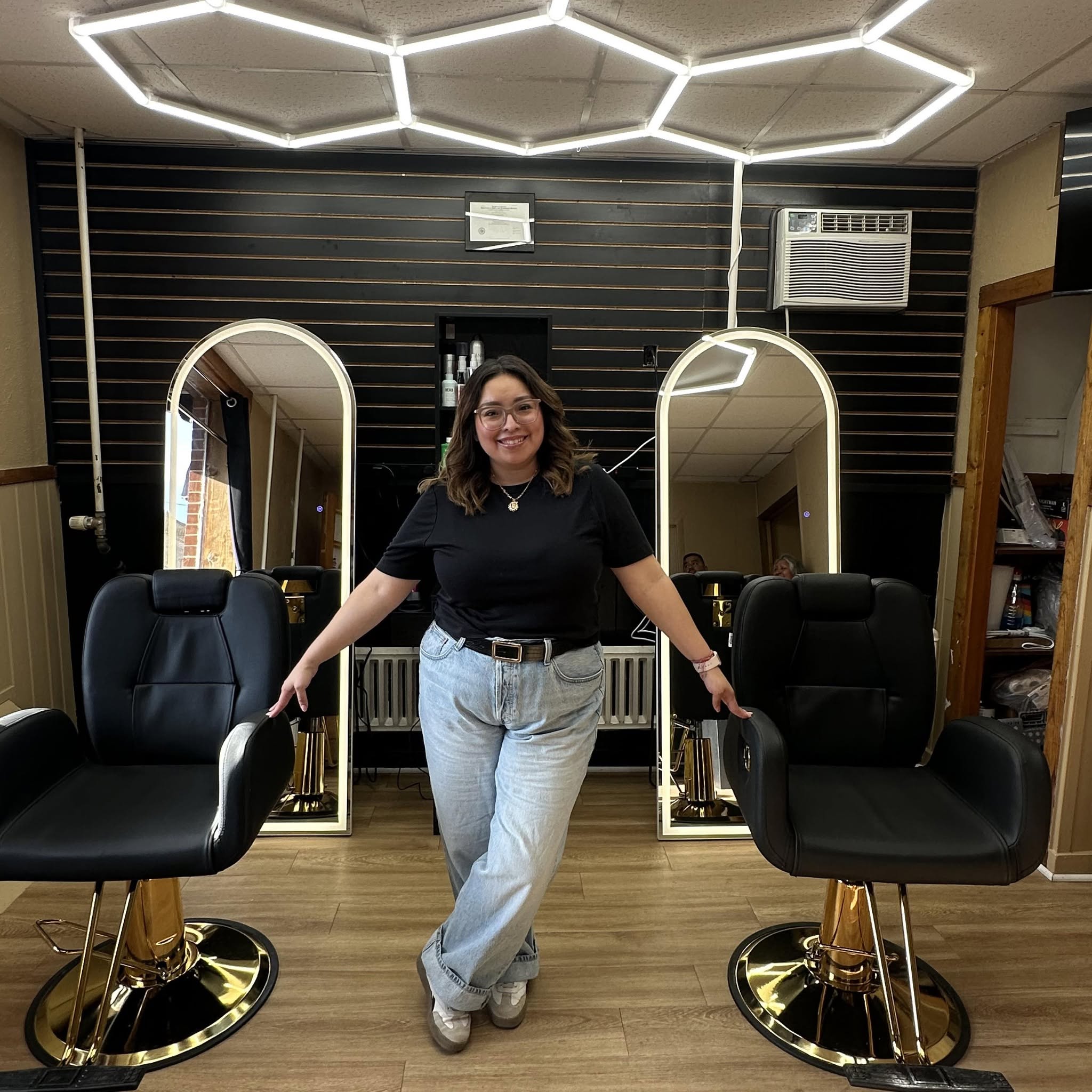 Dulce Salvador smiling inside D&L Studio LLC barbershop in Columbus, WI