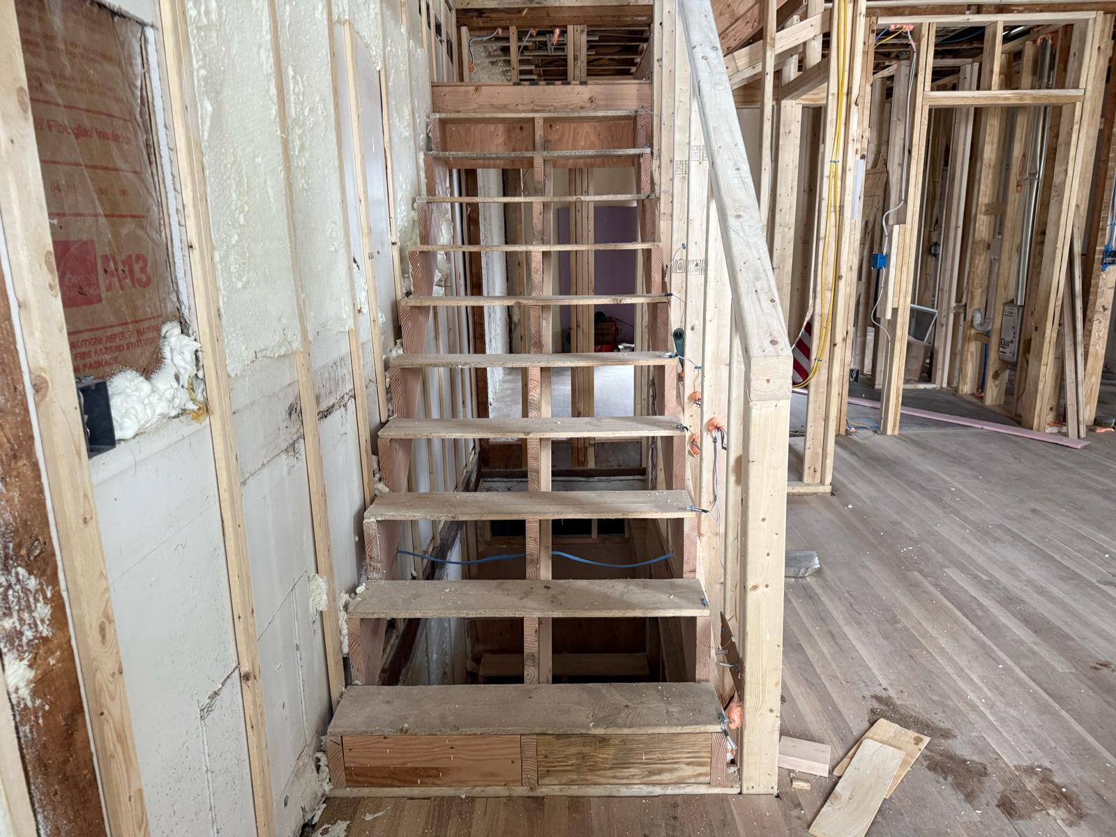Rough-in wiring for step accent lights along framed open staircase by Prime Light Electric LLC in Grafton MA