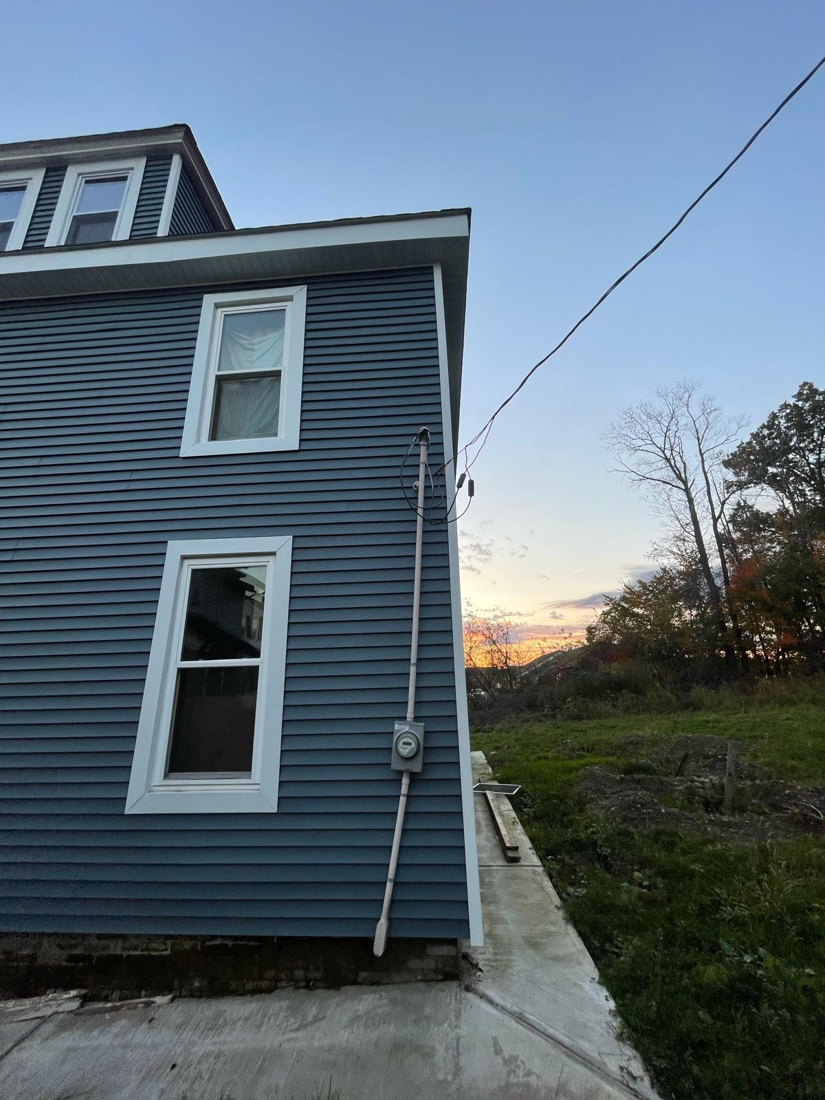 Exterior electrical service entrance mast, conduit, and meter base upgrade installed by Prime Light Electric LLC in Worcester MA