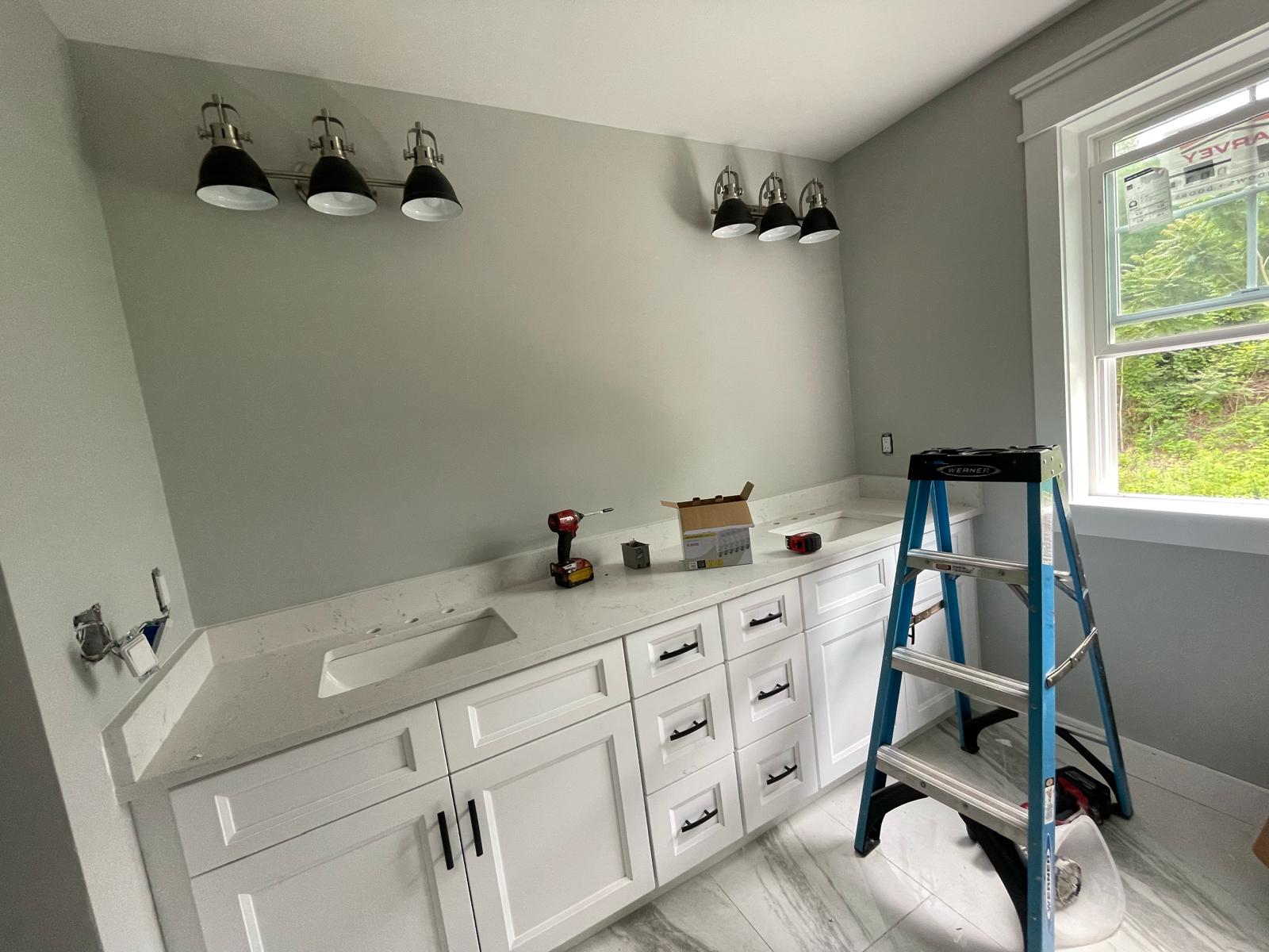 Master bath renovation with dual black and nickel vanity light fixtures and dedicated GFCI circuits by Prime Light Electric LLC in Shrewsbury MA