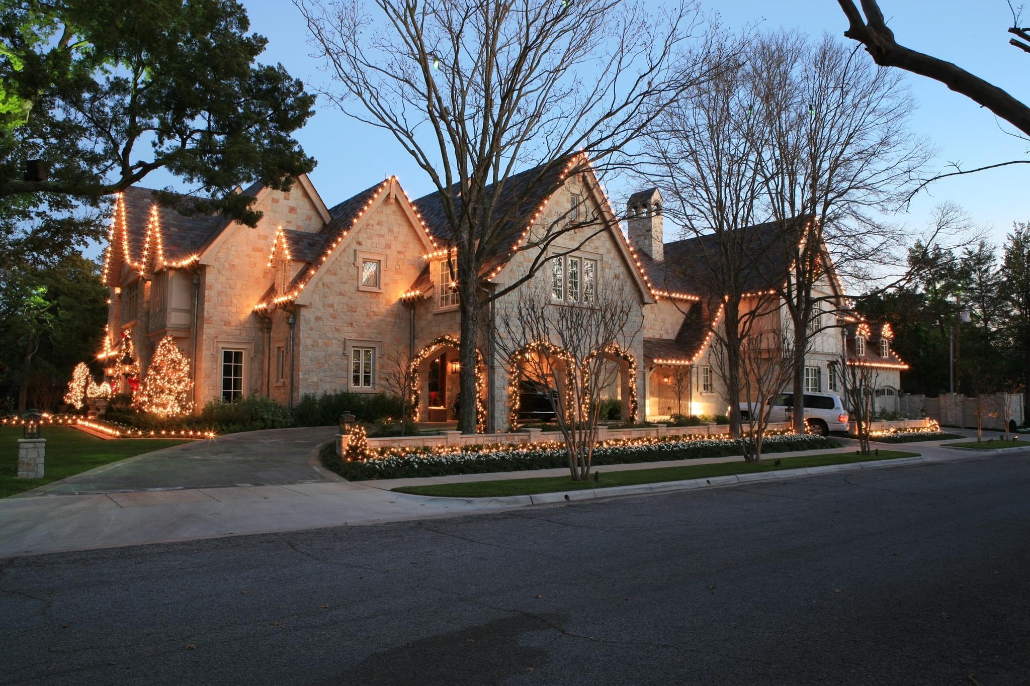 Christmas lights on home and trees