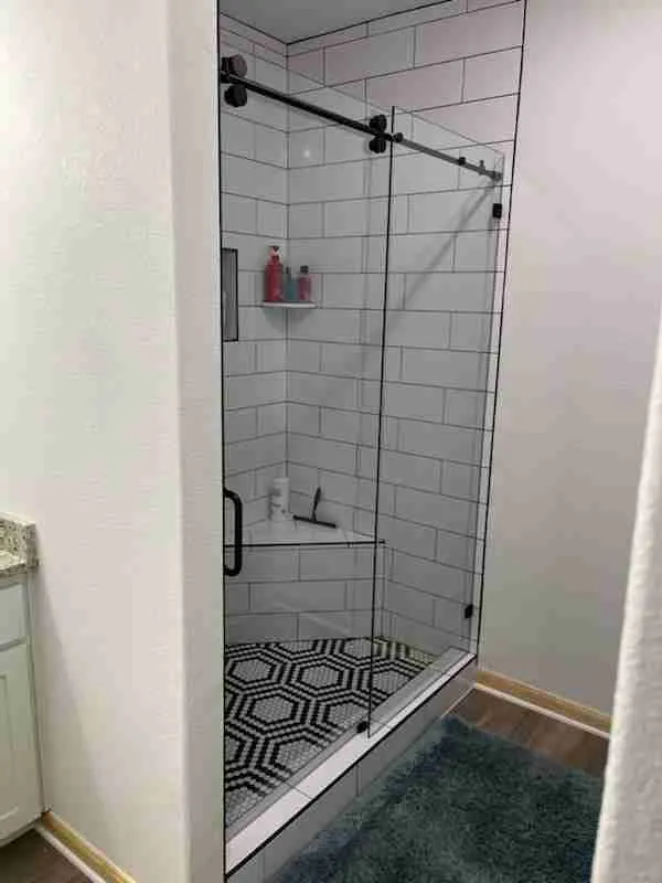 Sliding frameless glass shower door