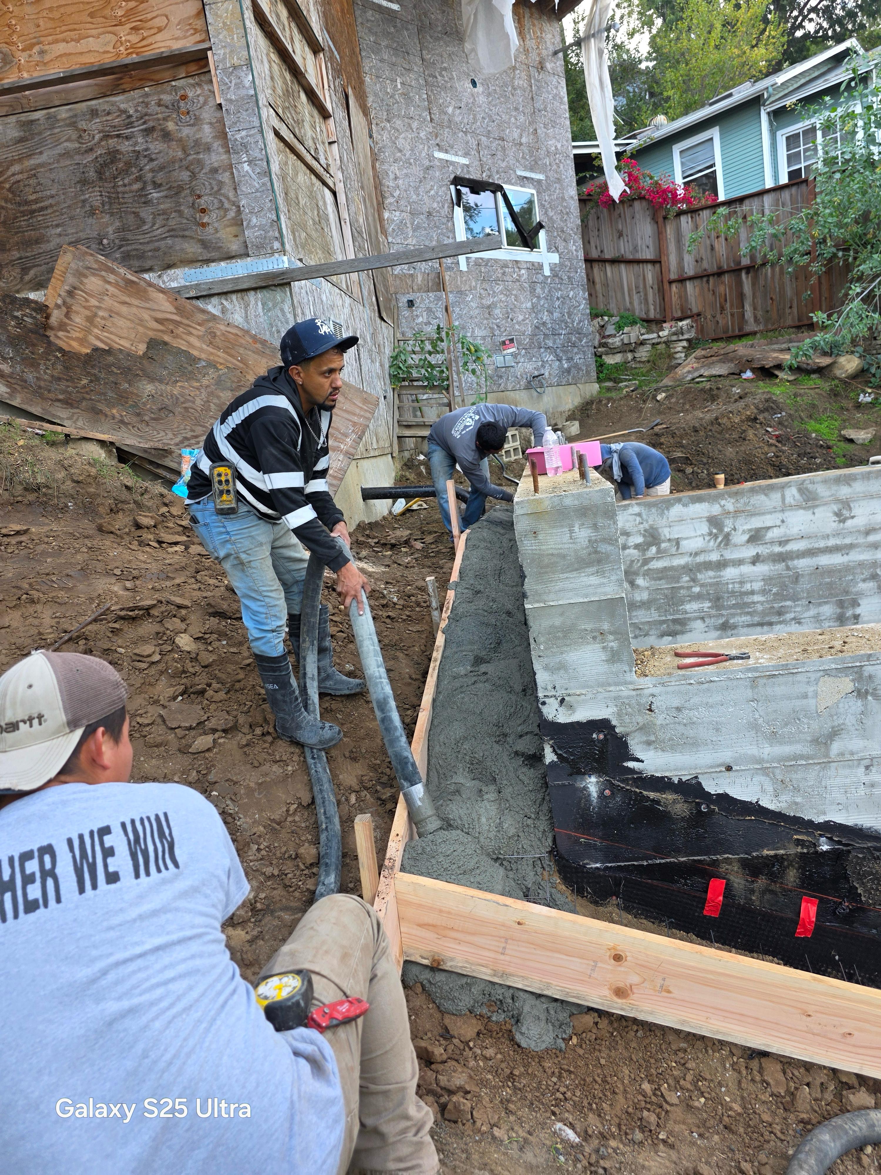 Hillside reinforced concrete retaining wall and foundation pour by LA Builder crew