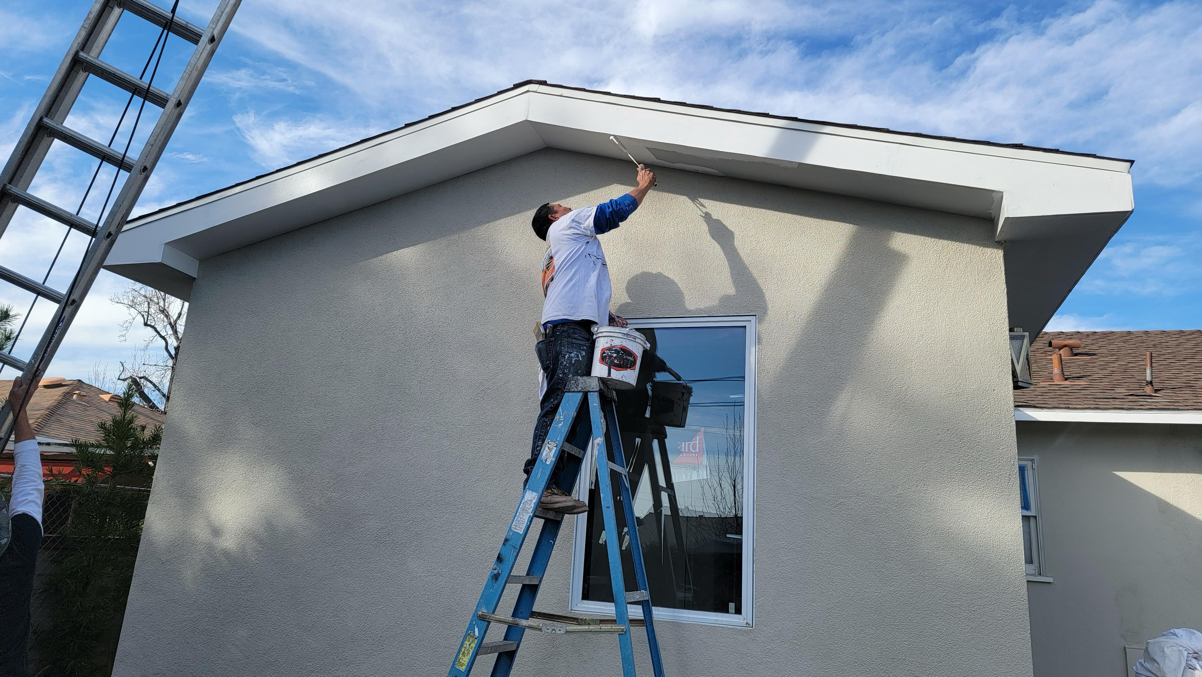 Exterior stucco, painting, and trim finishing work on residential home by LA Builder