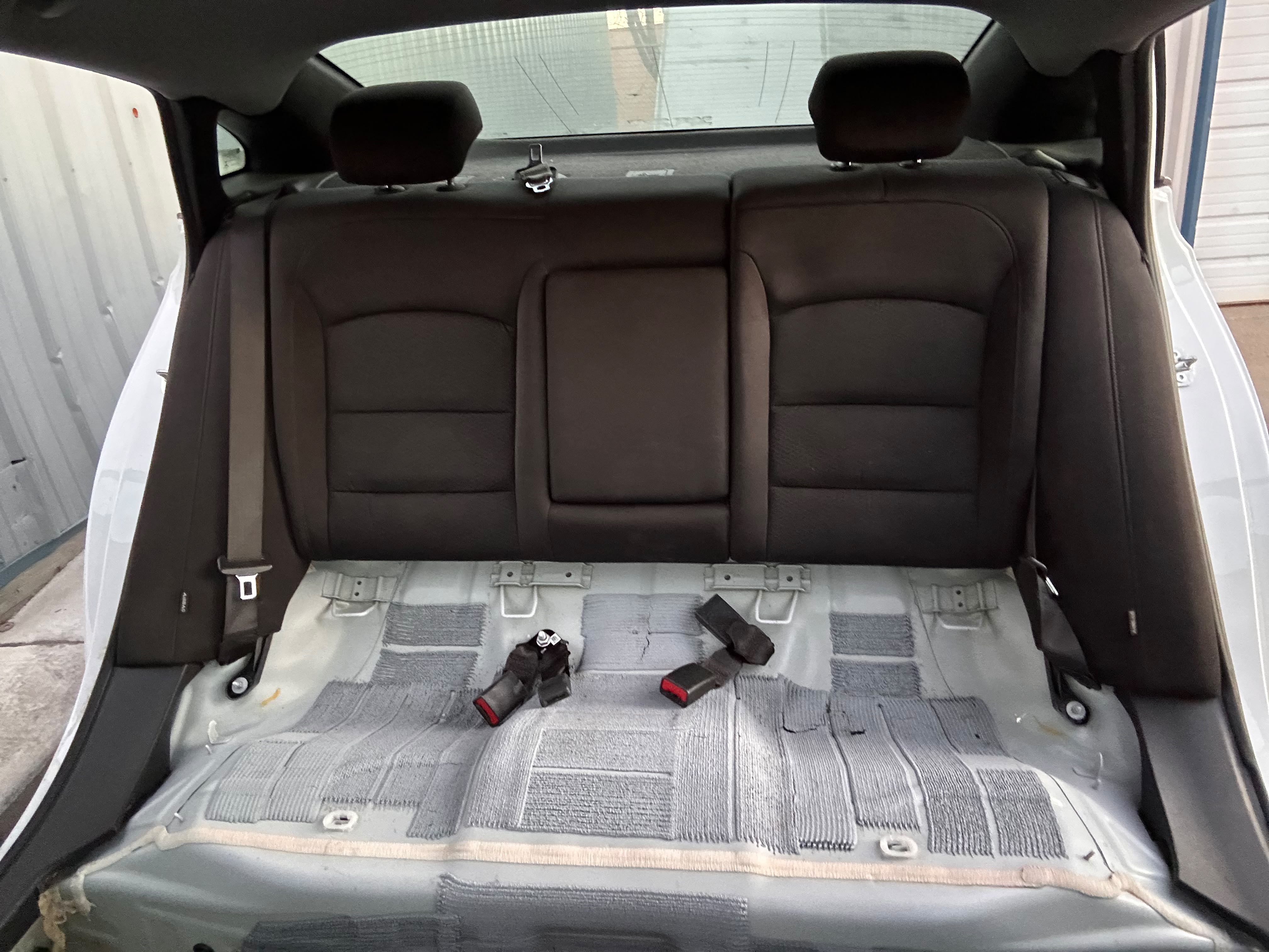 Vehicle back seats disassembled and carpet floor pan steam cleaned during complete interior extraction detail by Miracle Detailing