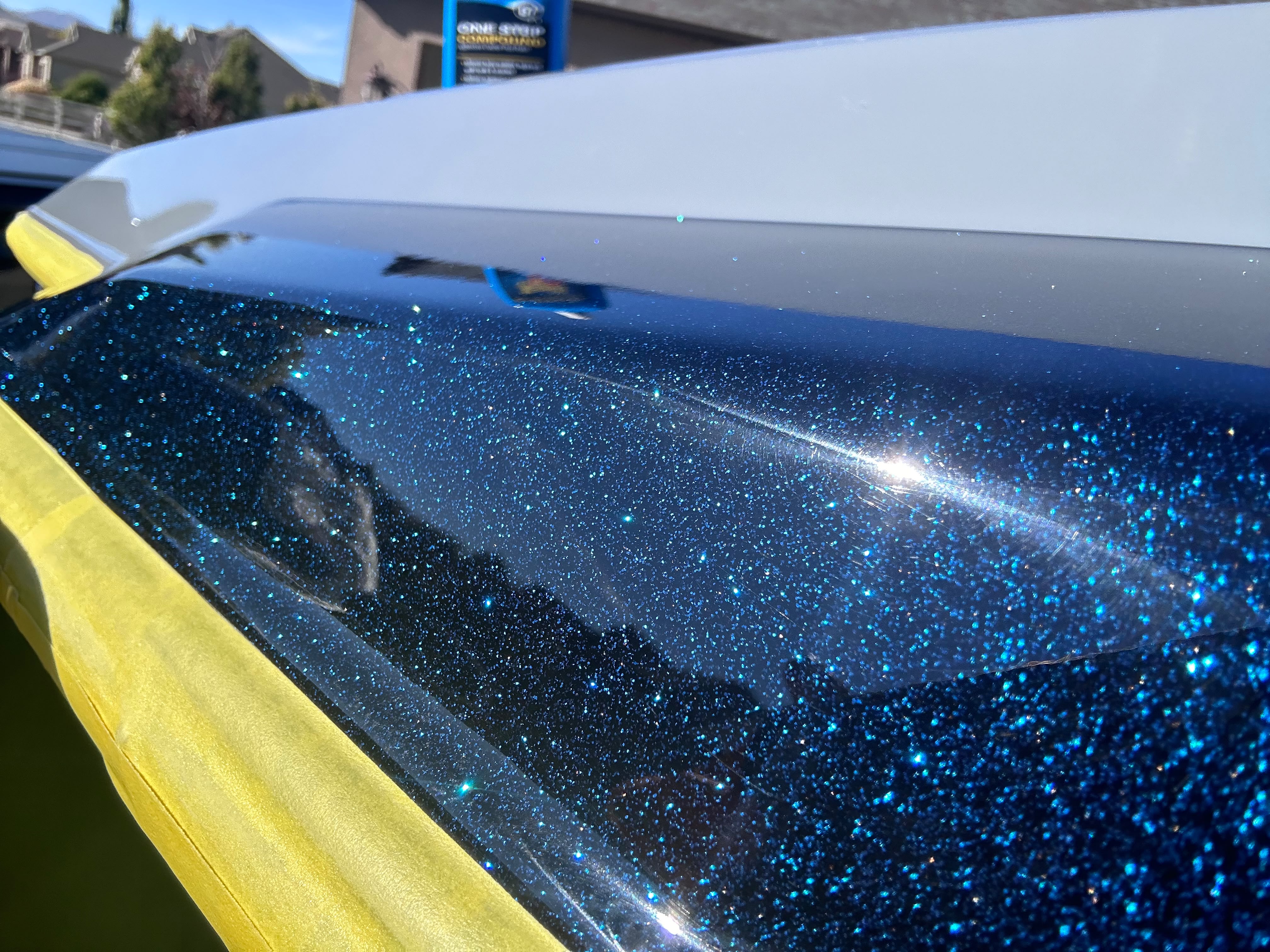 Deep blue metallic flake wakeboard boat gelcoat compounding and polish correction under sunlight by Miracle Detailing