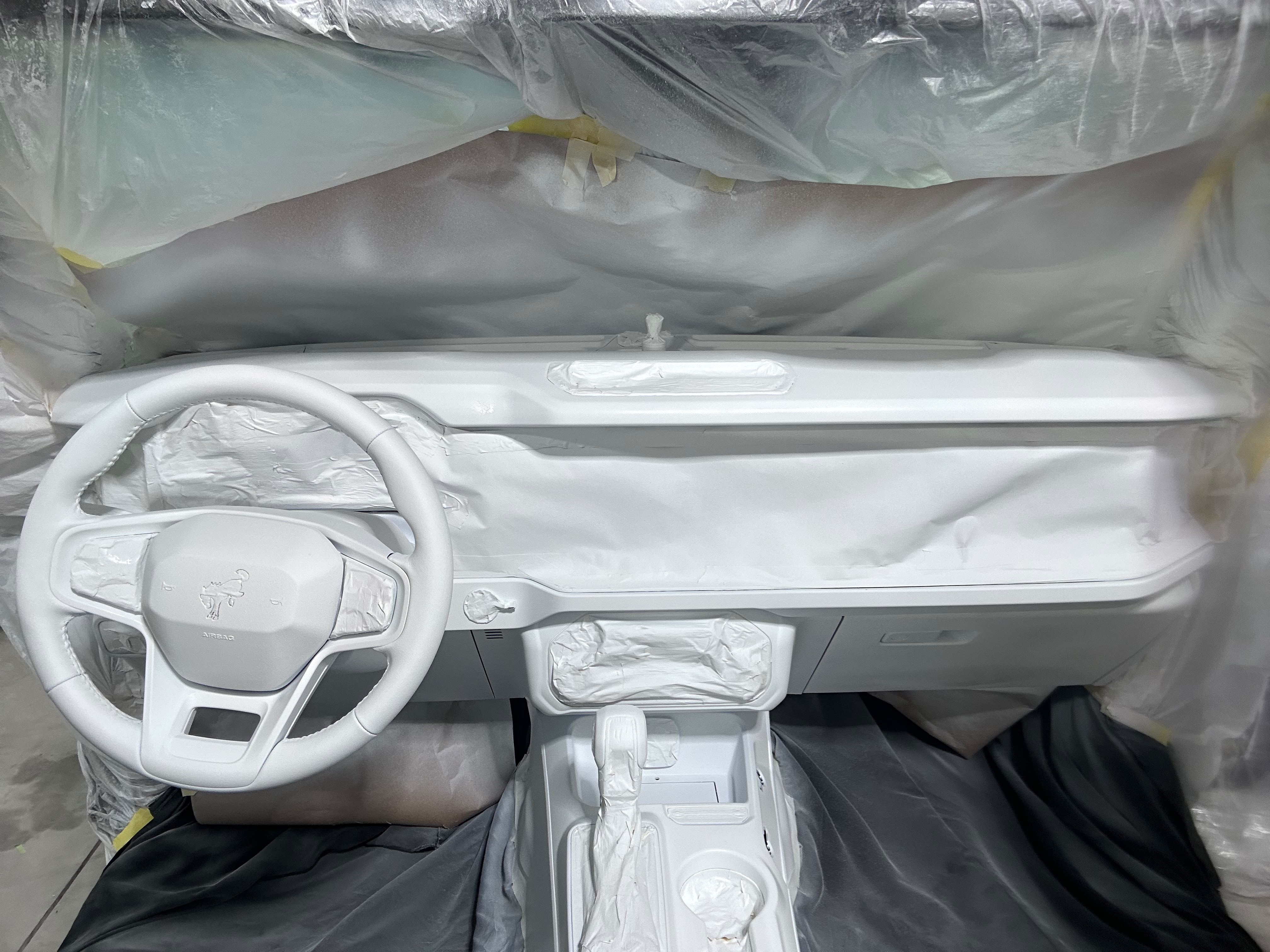 Vehicle steering wheel, dashboard console, and cockpit surfaces masked with precision for interior protective coating application by Miracle Detailing in Lindon UT