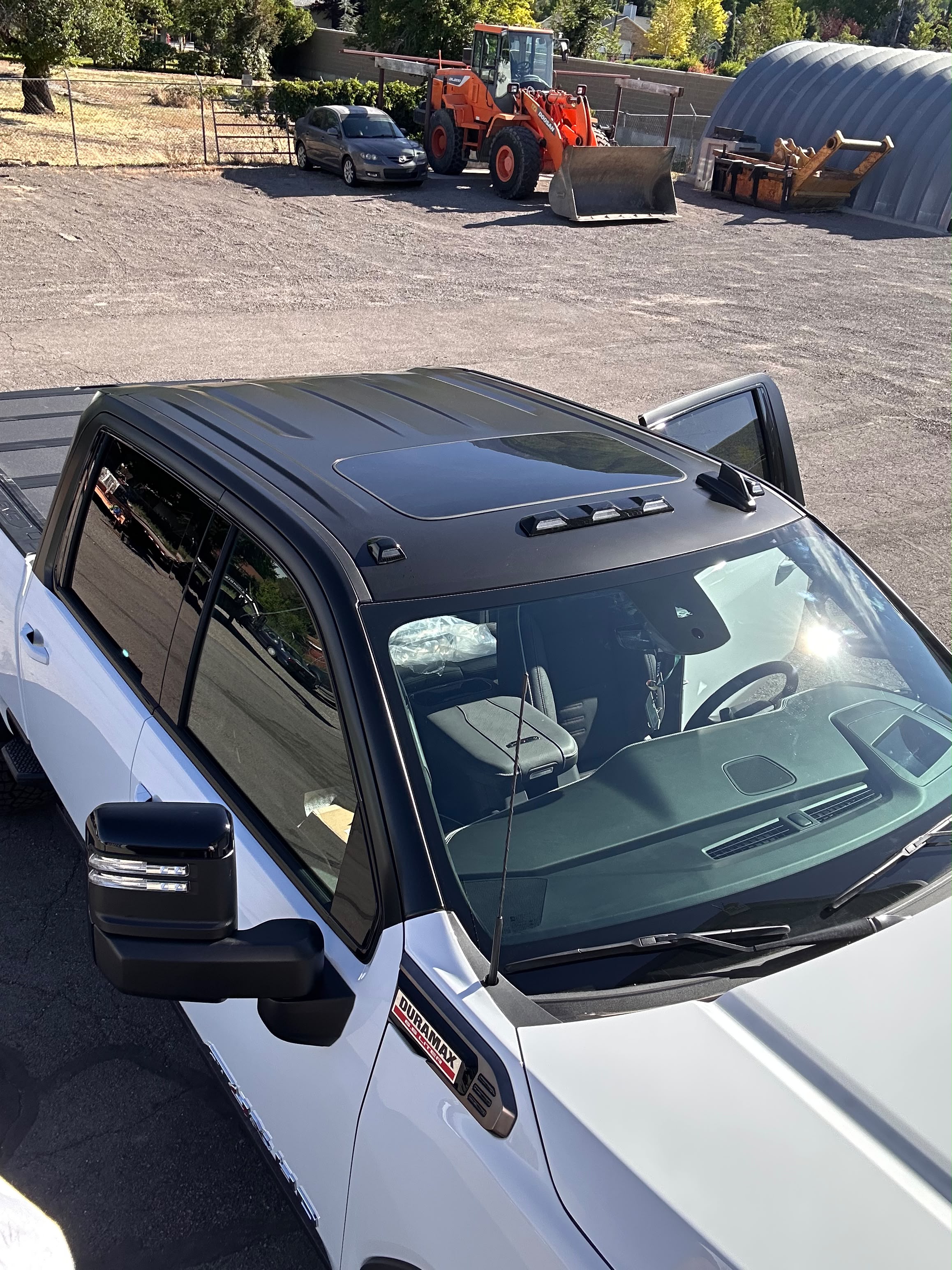 Duramax truck high angle overhead view of completed satin black tuxedo roof wrap in outdoor Utah sunlight by Miracle Detailing