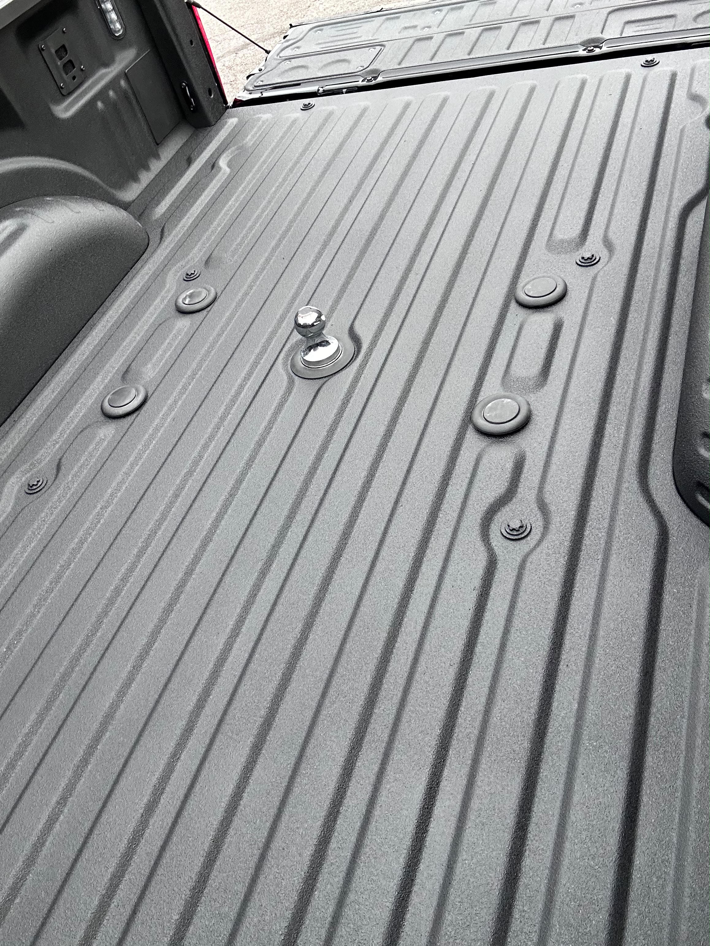 Close-up of newly sprayed textured Rhino Lining bed armor around fifth wheel gooseneck hitch by Miracle Detailing Lindon UT