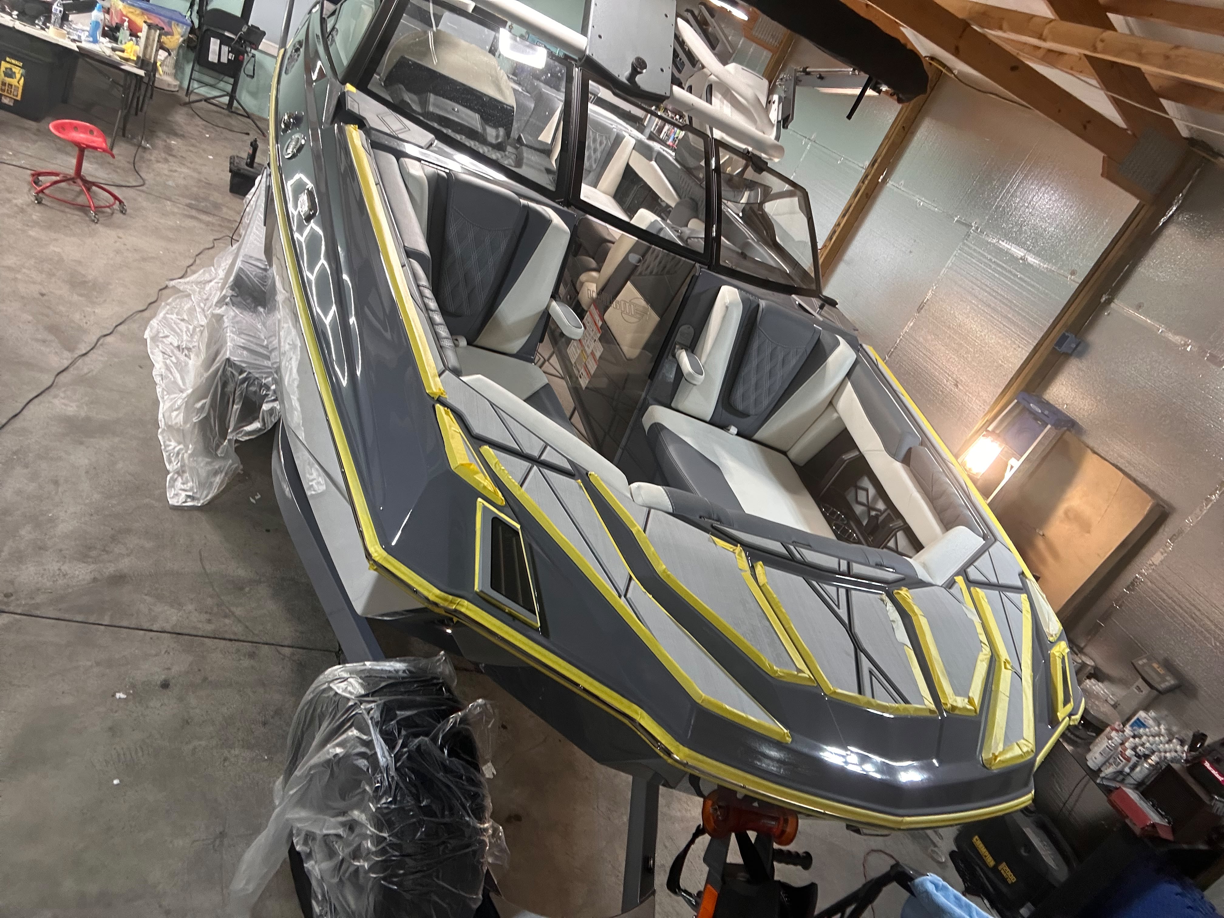 High-performance wakeboard boat masked and prepped for multi-stage gelcoat paint restoration by Miracle Detailing