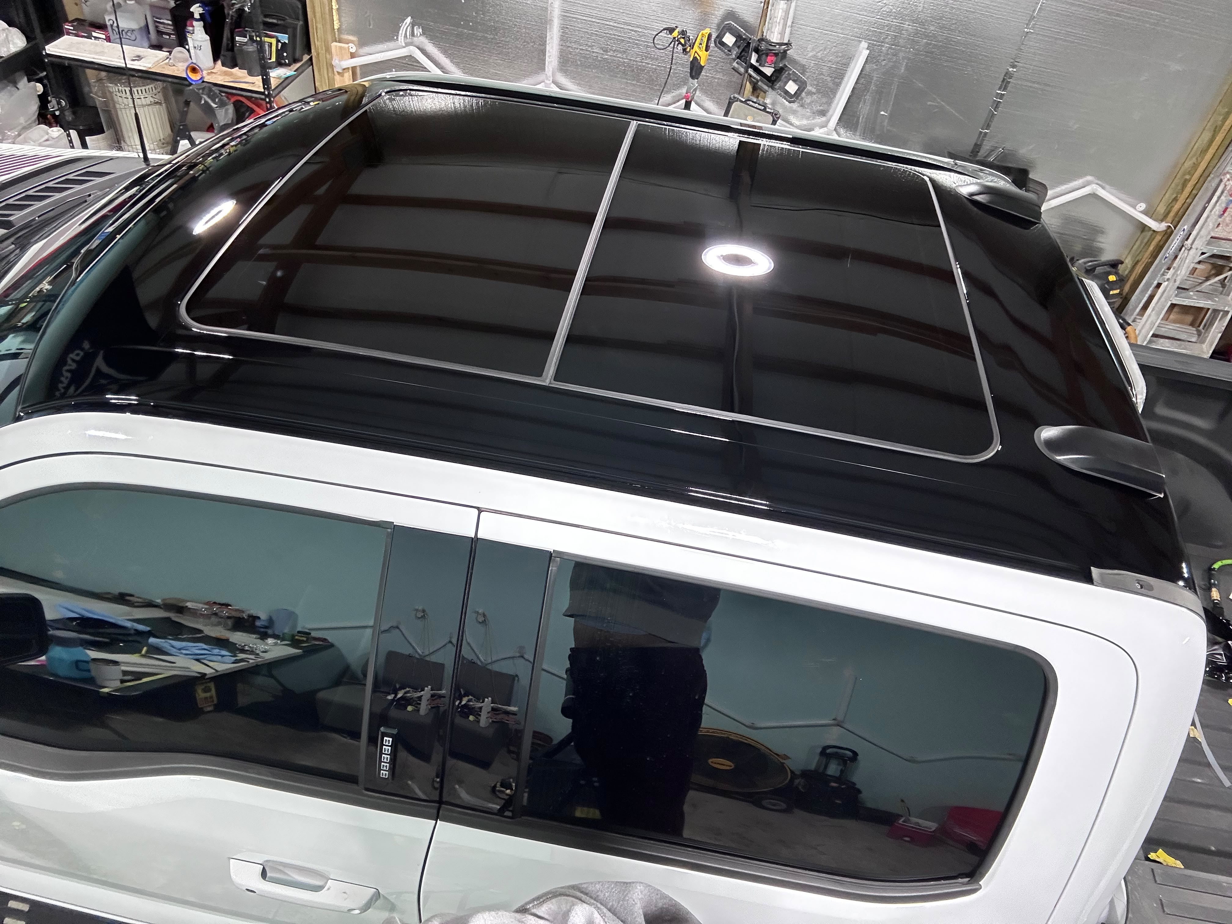 High-angle overhead view of truck dual-pane panoramic sunroof and gloss black tuxedo roof wrap completed by Miracle Detailing