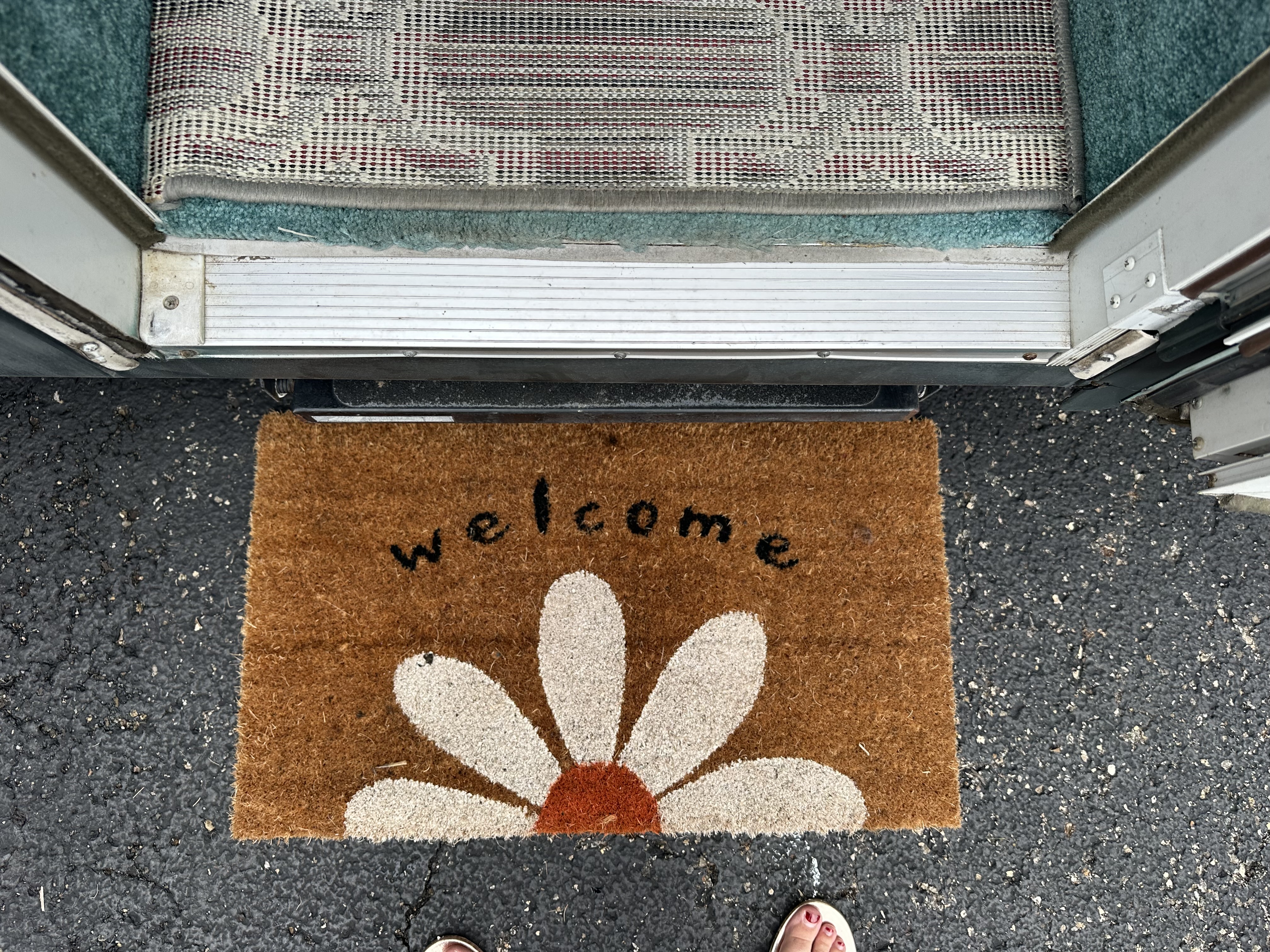 Daisy welcome mat at the RV entry steps