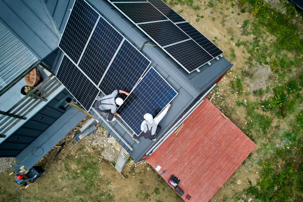 Hot Solar Solutions crew installing solar panels on a home roof