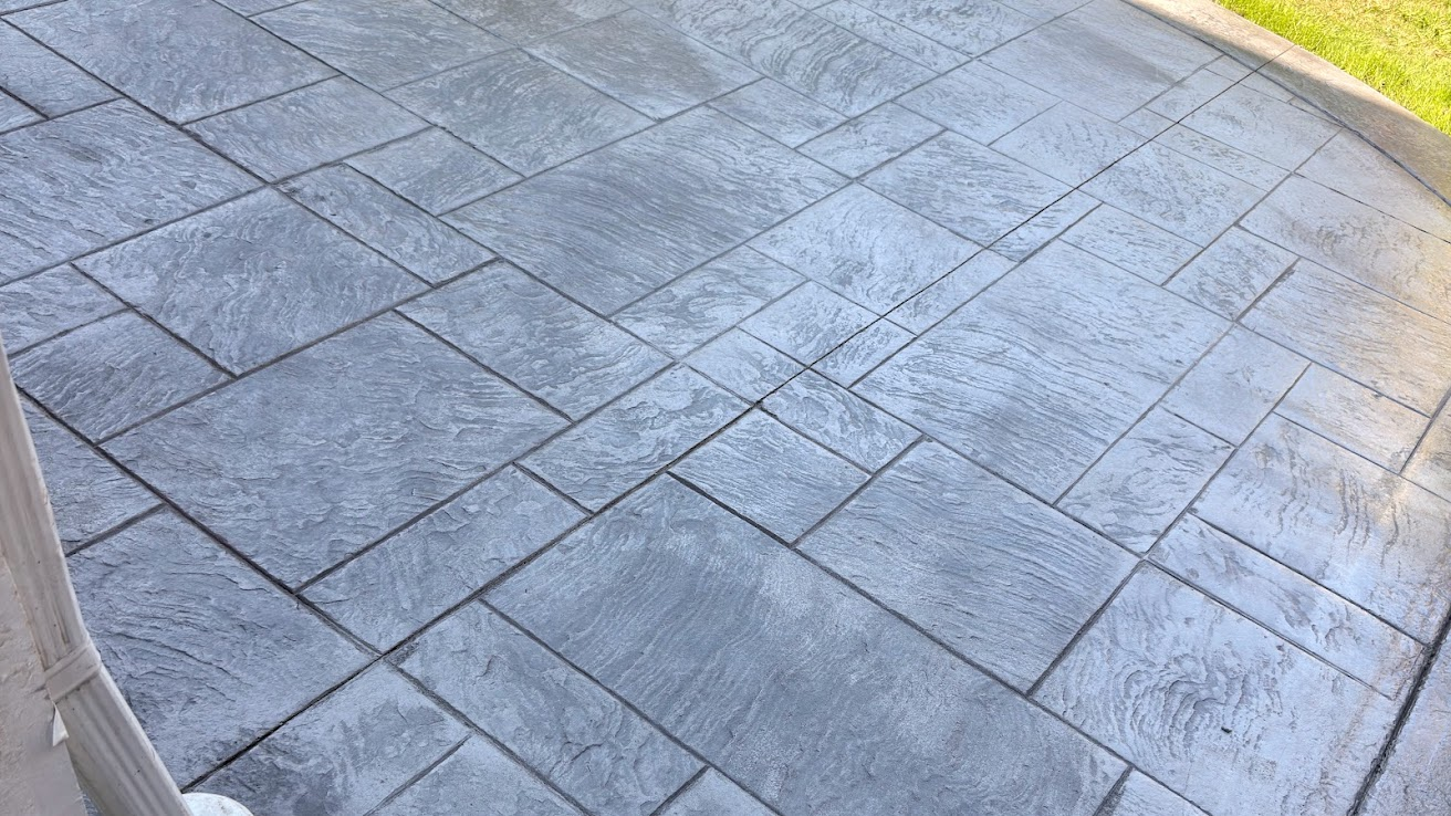 Close view of a stamped concrete patio with rectangular stone pattern