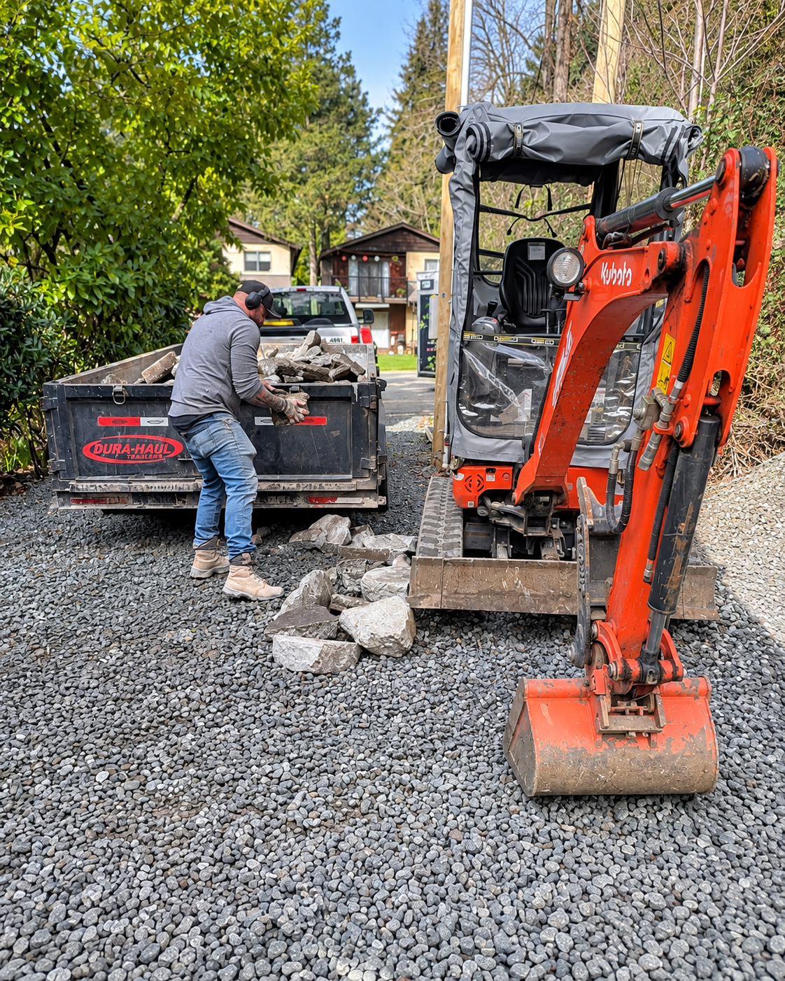 Can Concrete excavator and dump trailer removing demolished material from a residential site