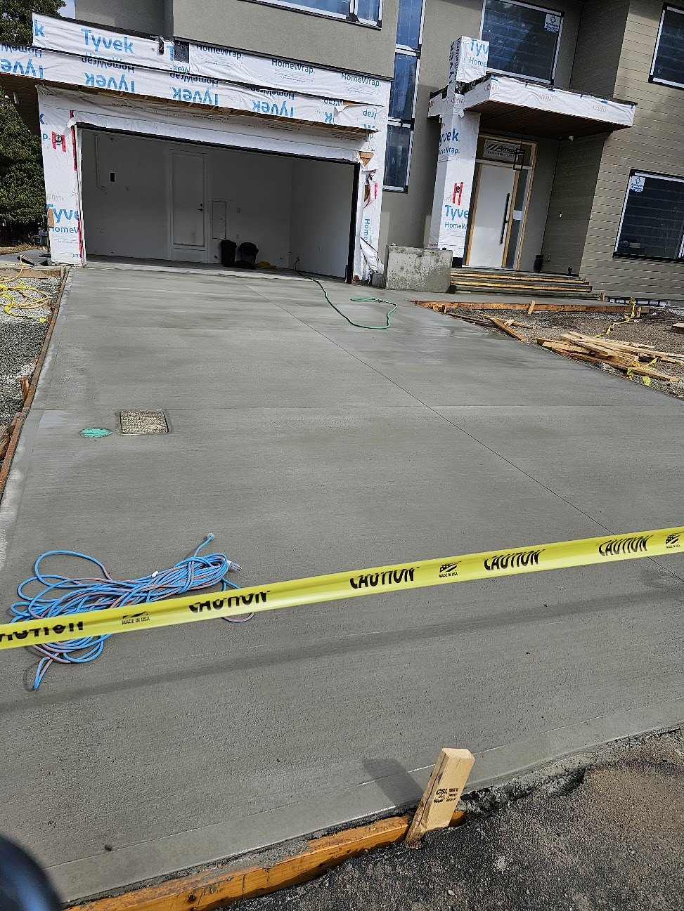 Finished residential concrete driveway in front of a new home