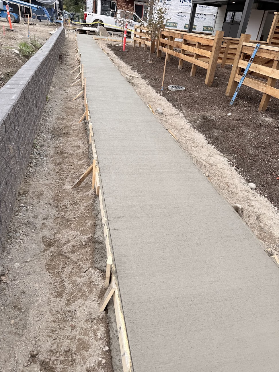 Concrete sidewalk with timber edge forms still in place after placement