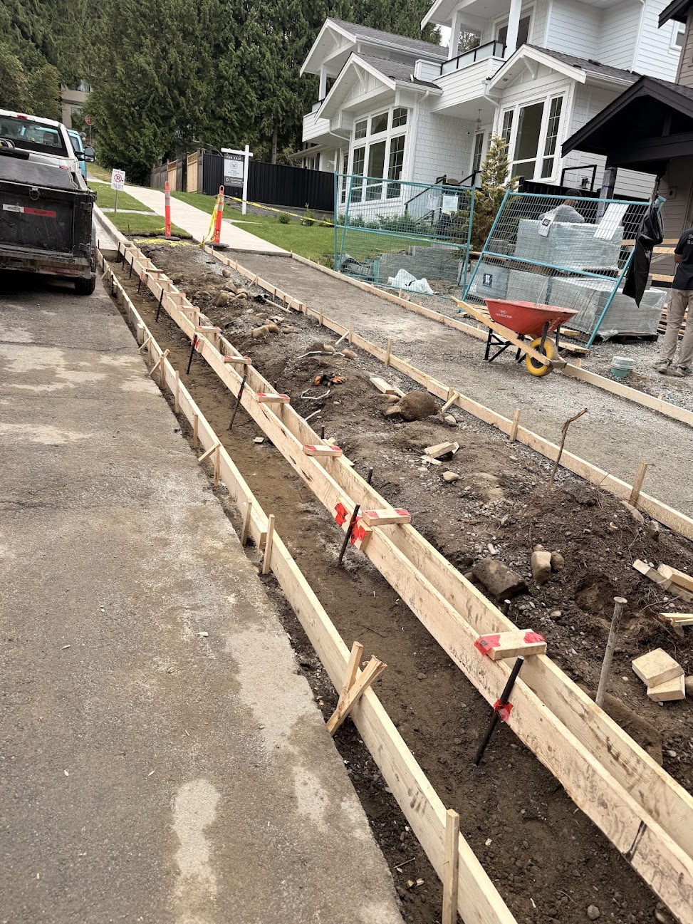 Timber forms installed for curb and sidewalk concrete work.