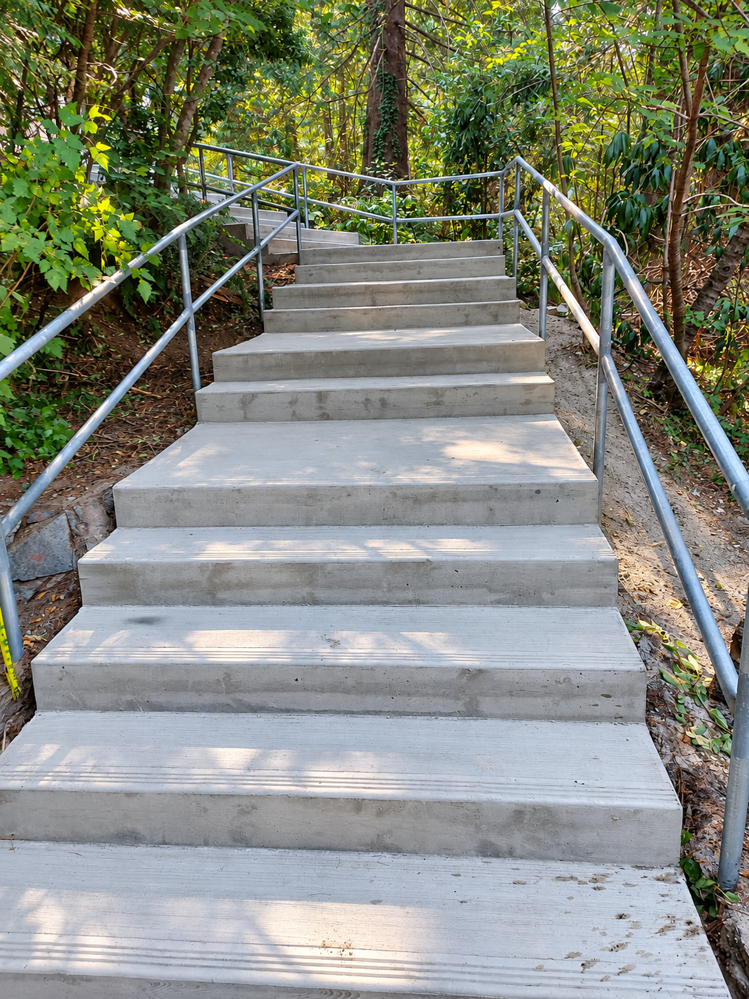 Residential concrete entry steps and walkway during concrete installation.