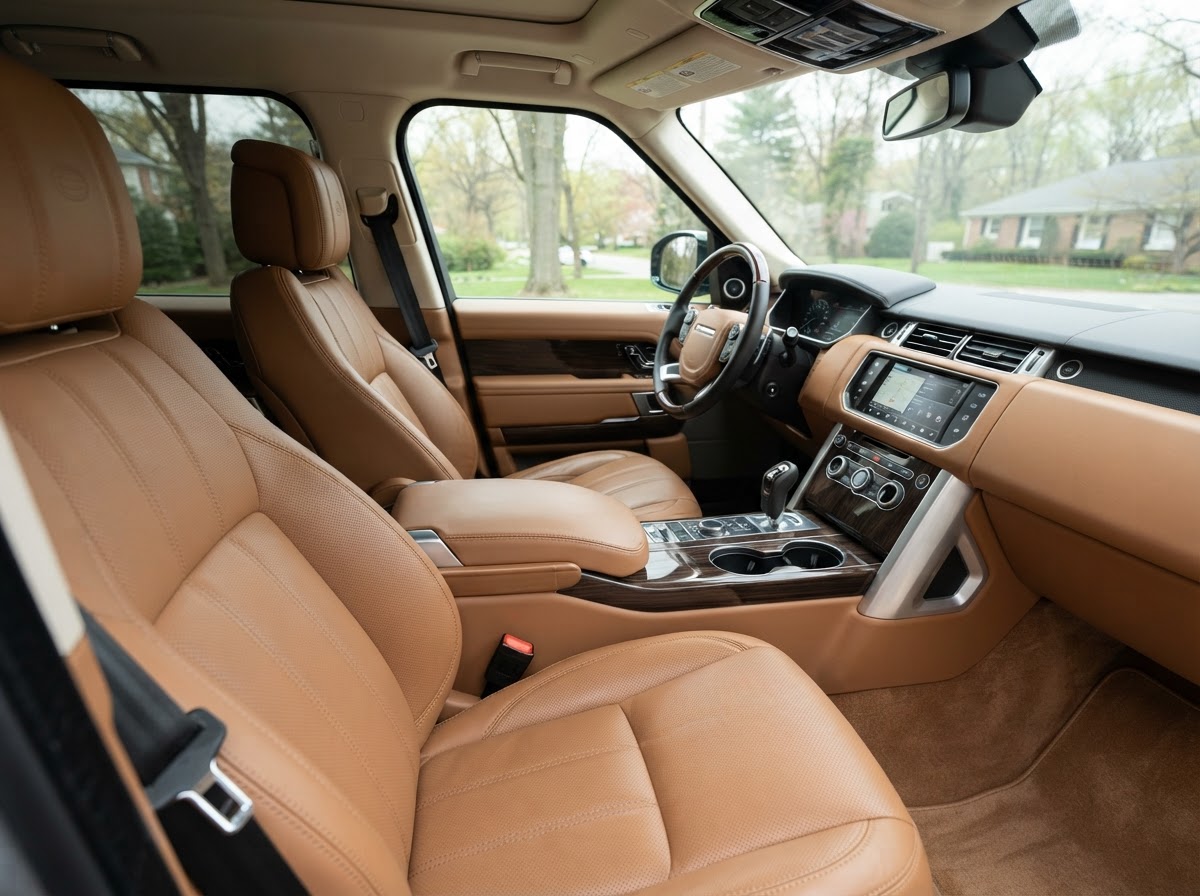 Freshly cleaned tan leather seats and console in a premium SUV after interior detailing