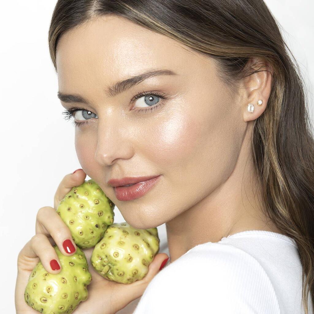 Miranda Kerr holding fresh noni fruits