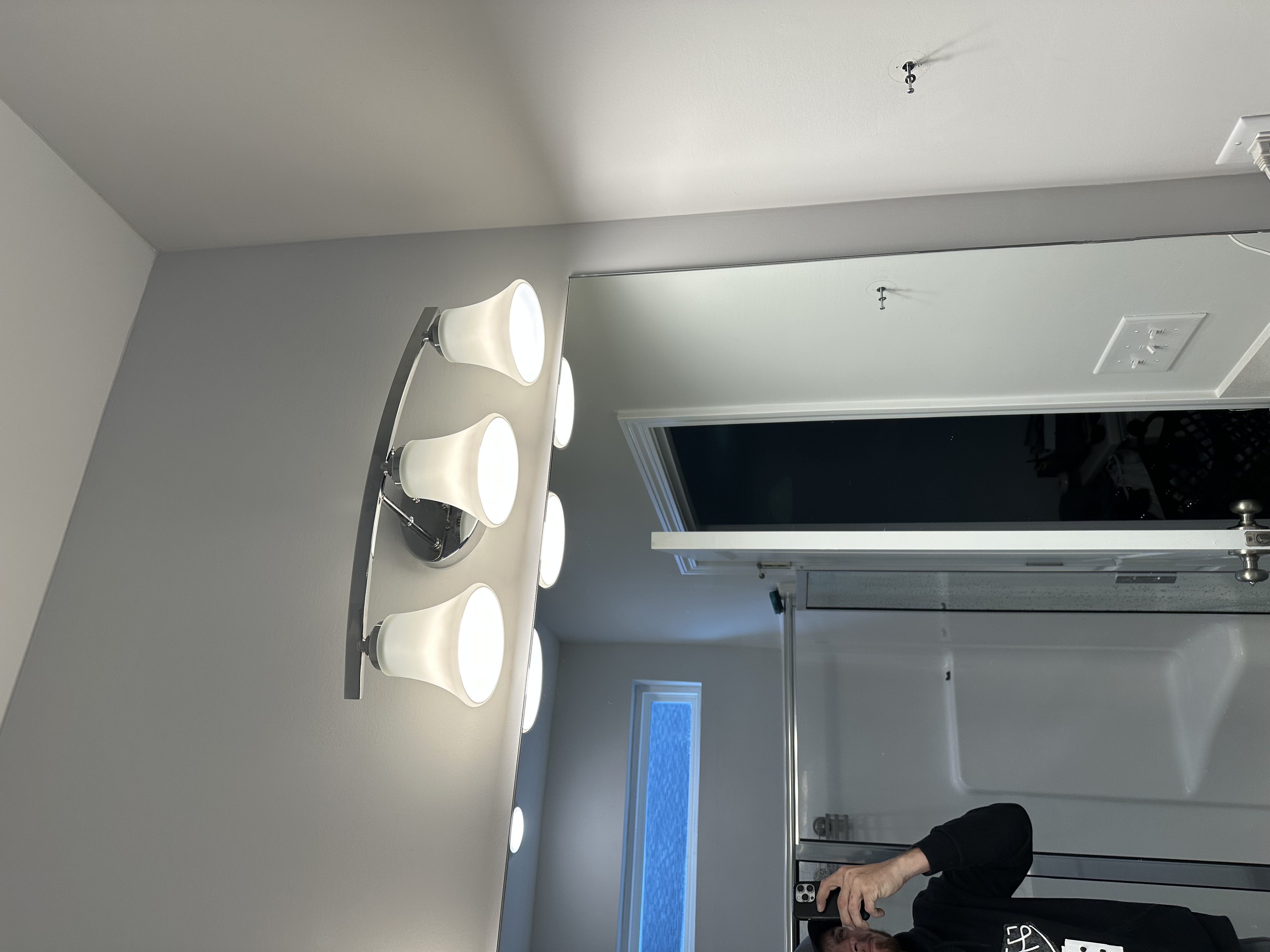 Modern bathroom vanity light fixture installation by Soundside Electrical in Wilmington NC