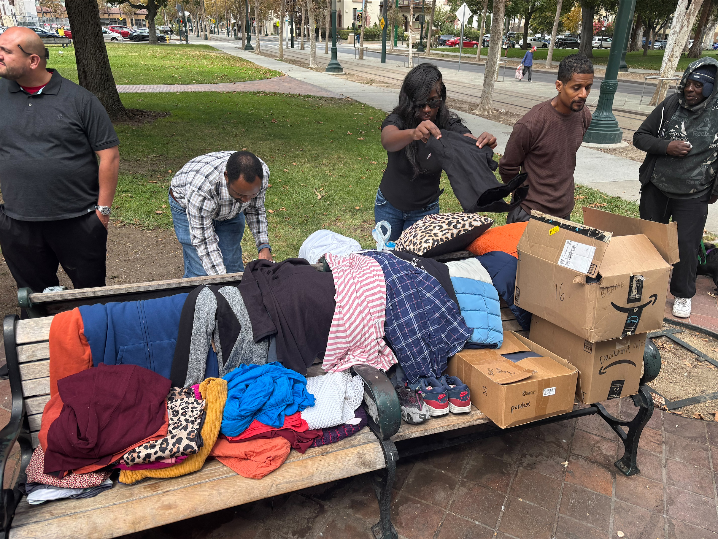 Volunteers organizing clothing and essential supplies for community members