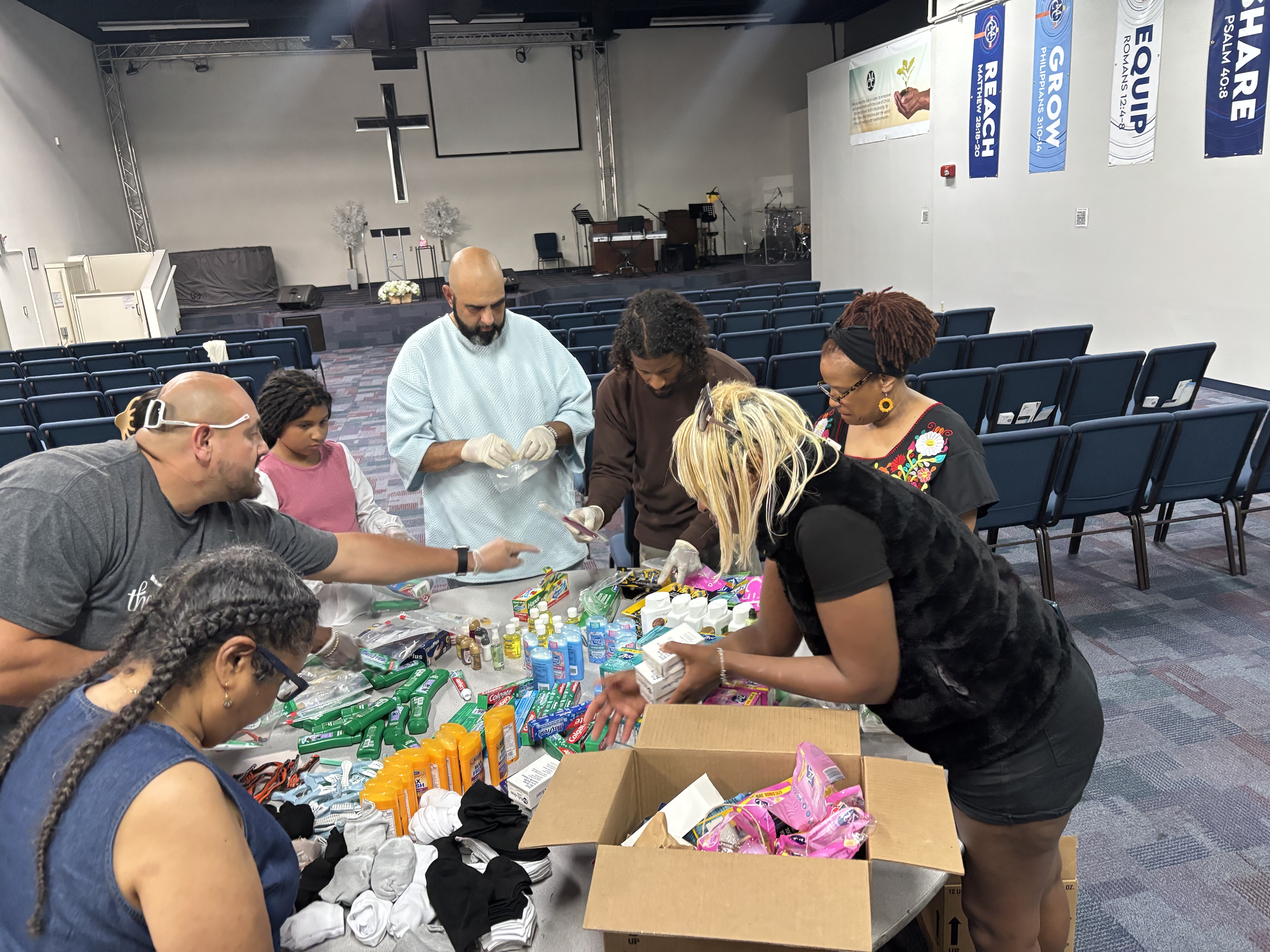 Volunteers and staff packaging care packs and essentials at Mission Possible