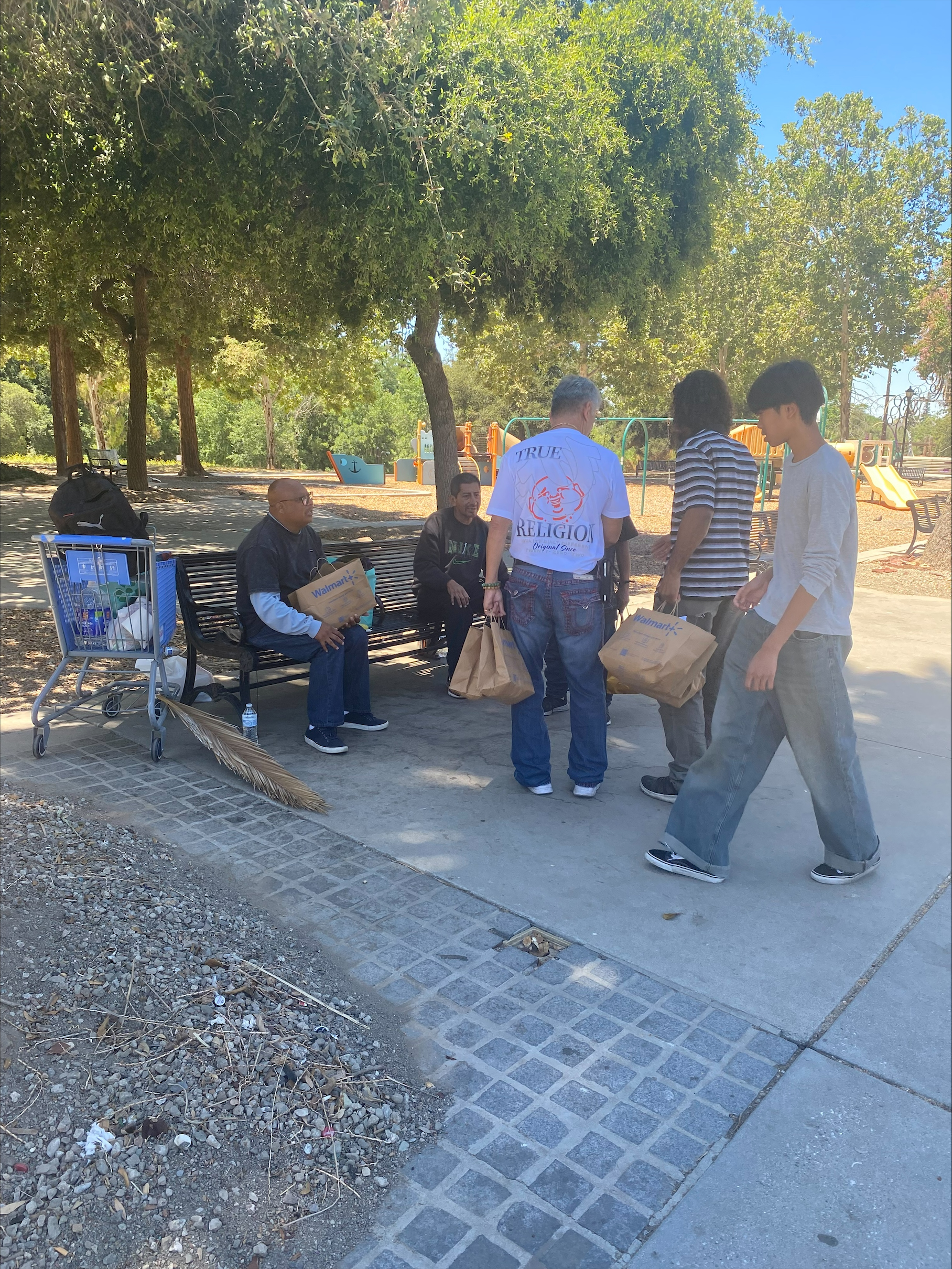 Mission Possible team members distributing food packages in the park