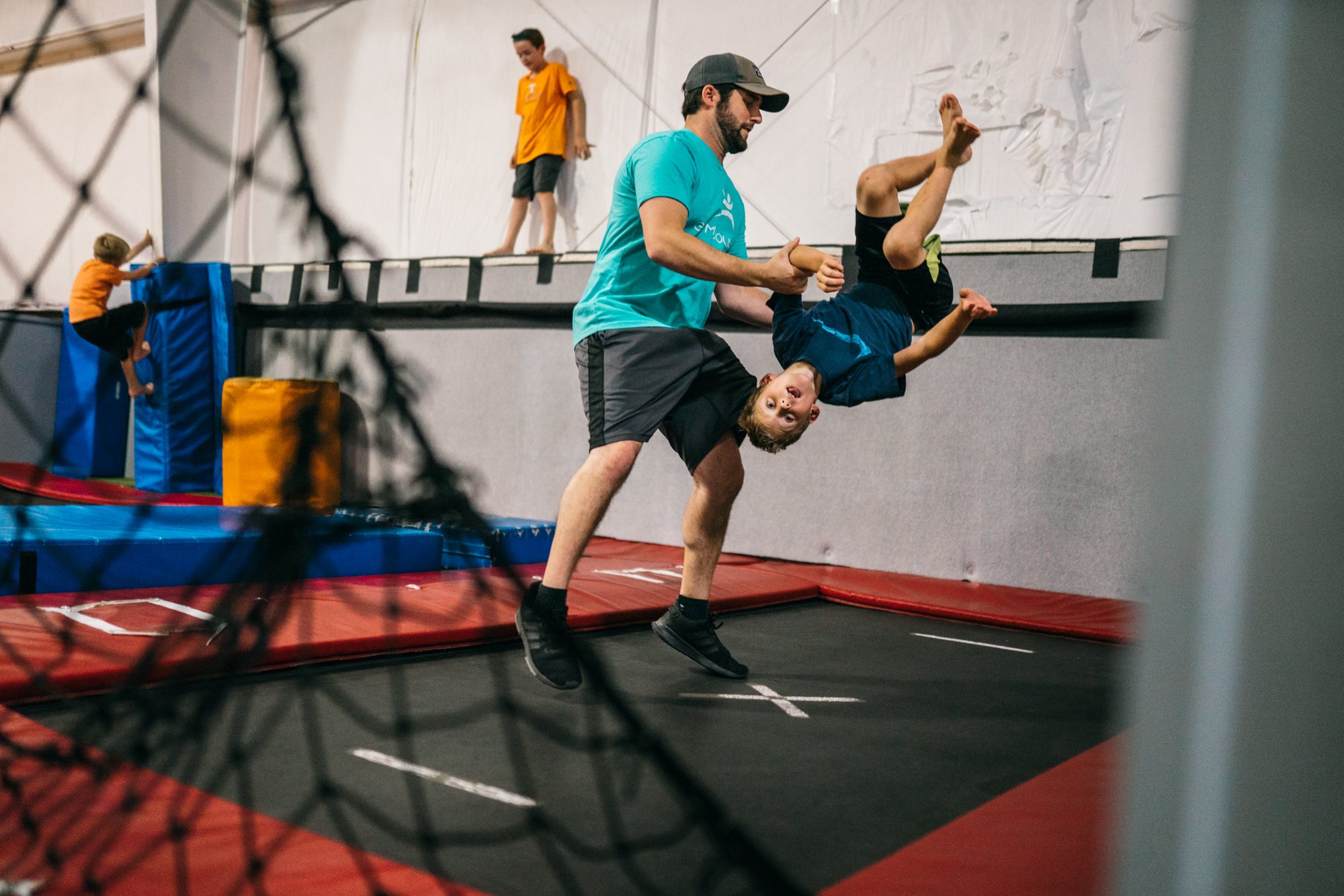 Child hanging from rings in the Ninja area
