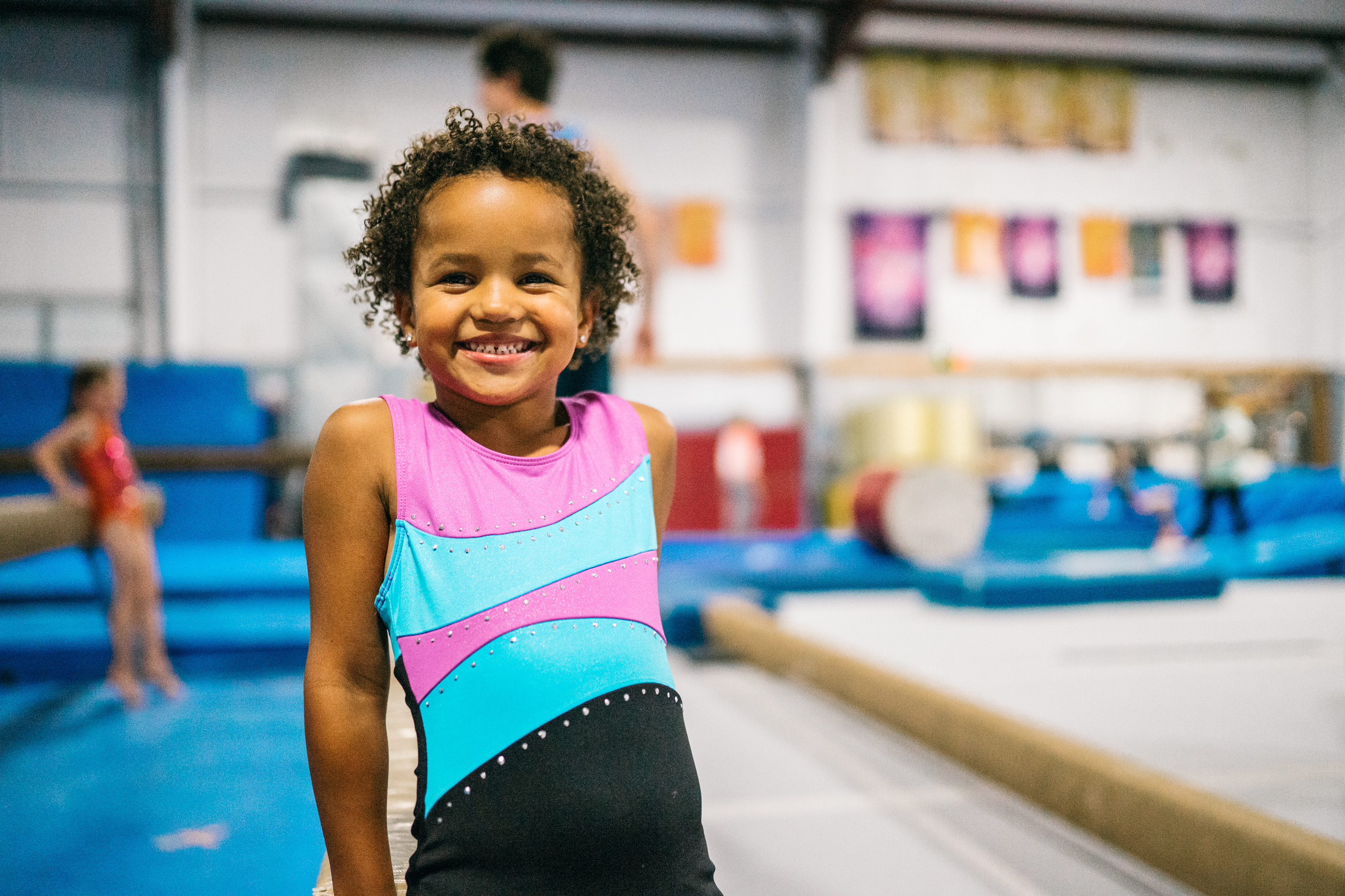 Young Gym Counts athlete raising their arms in celebration