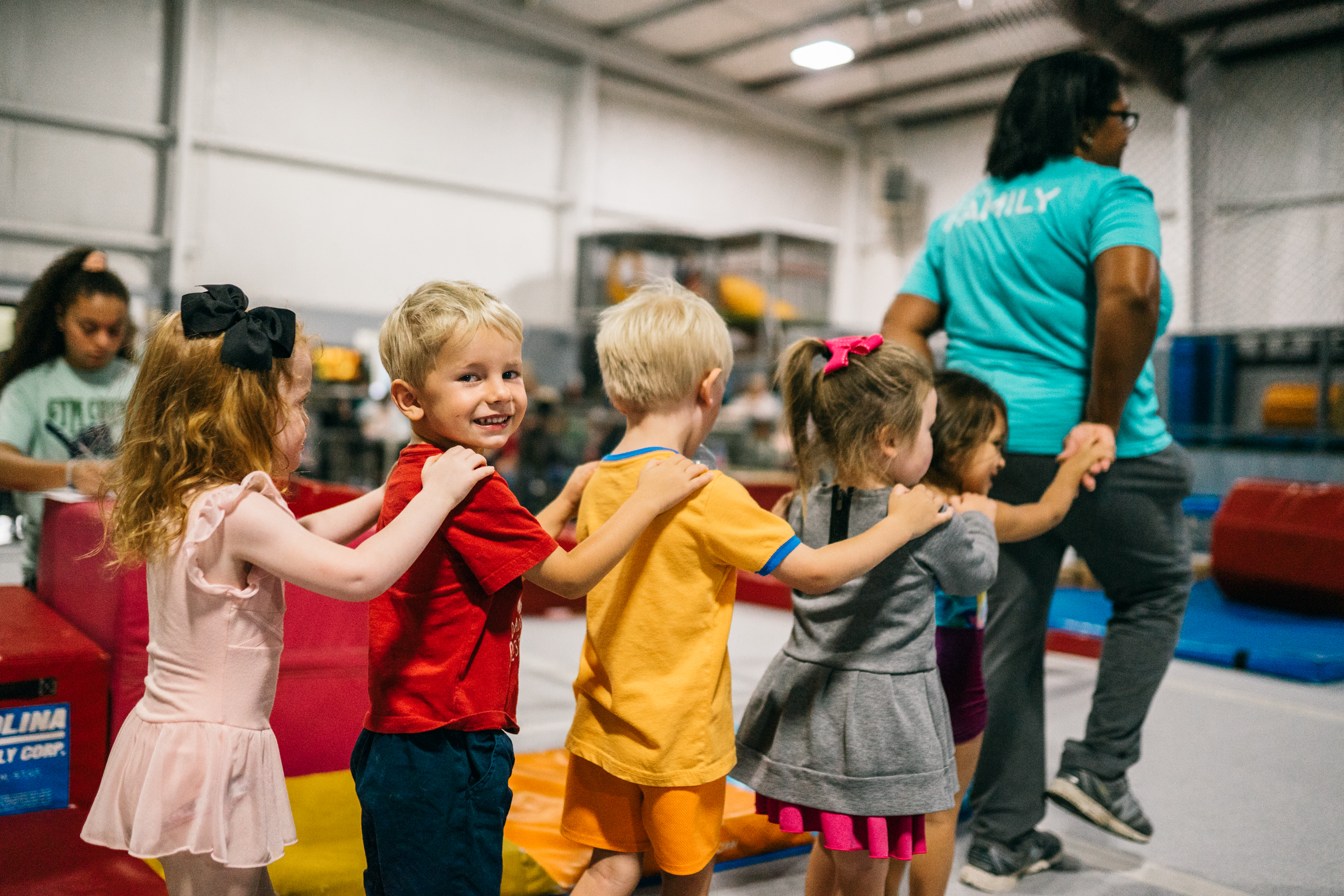 Preschool children lining up with their coach at Gym Counts